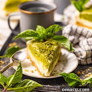 A slice of vibrant matcha cheesecake on a plate.