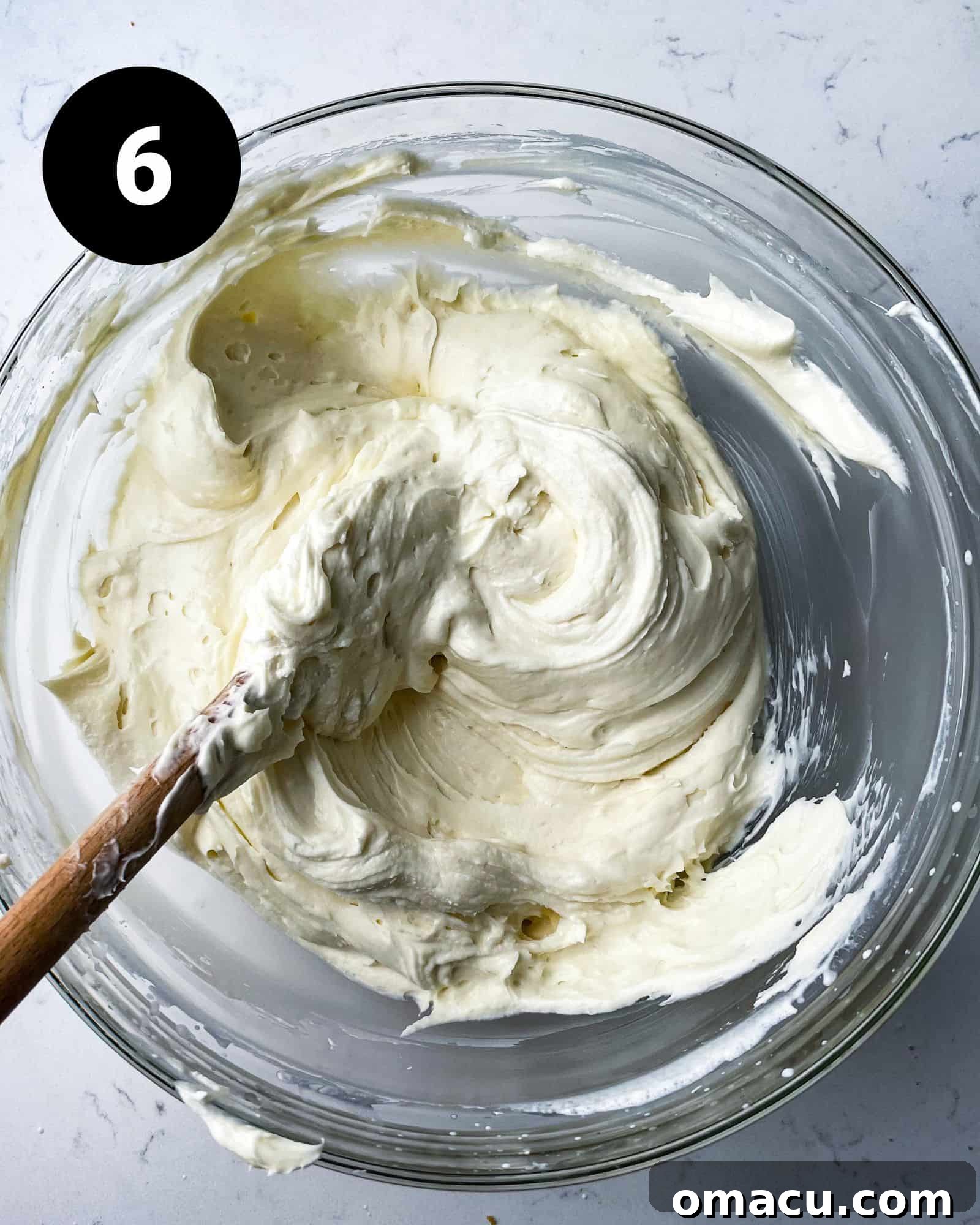 Whipped cream gently folded into the cream cheese mixture, creating a unified, fluffy batter.