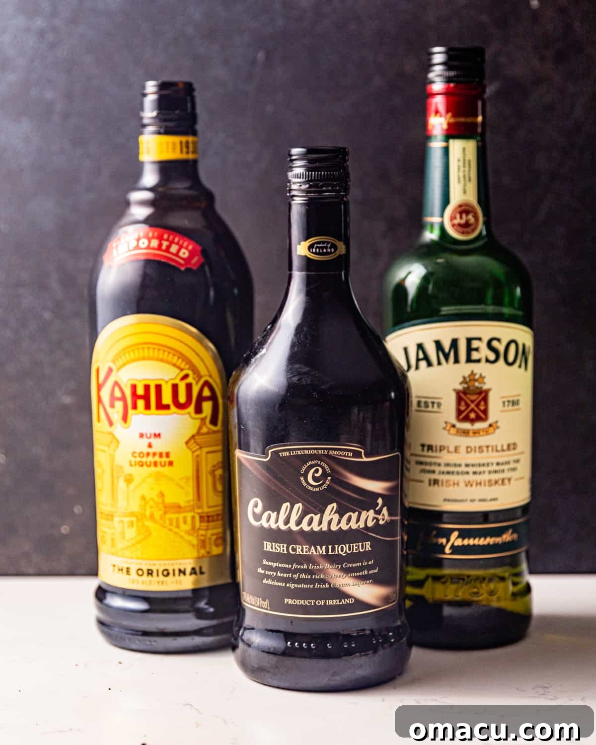 The essential ingredients for a Duck Fart Shot: Kahlua coffee liqueur, Bailey's Irish Cream, and a bottle of whiskey.
