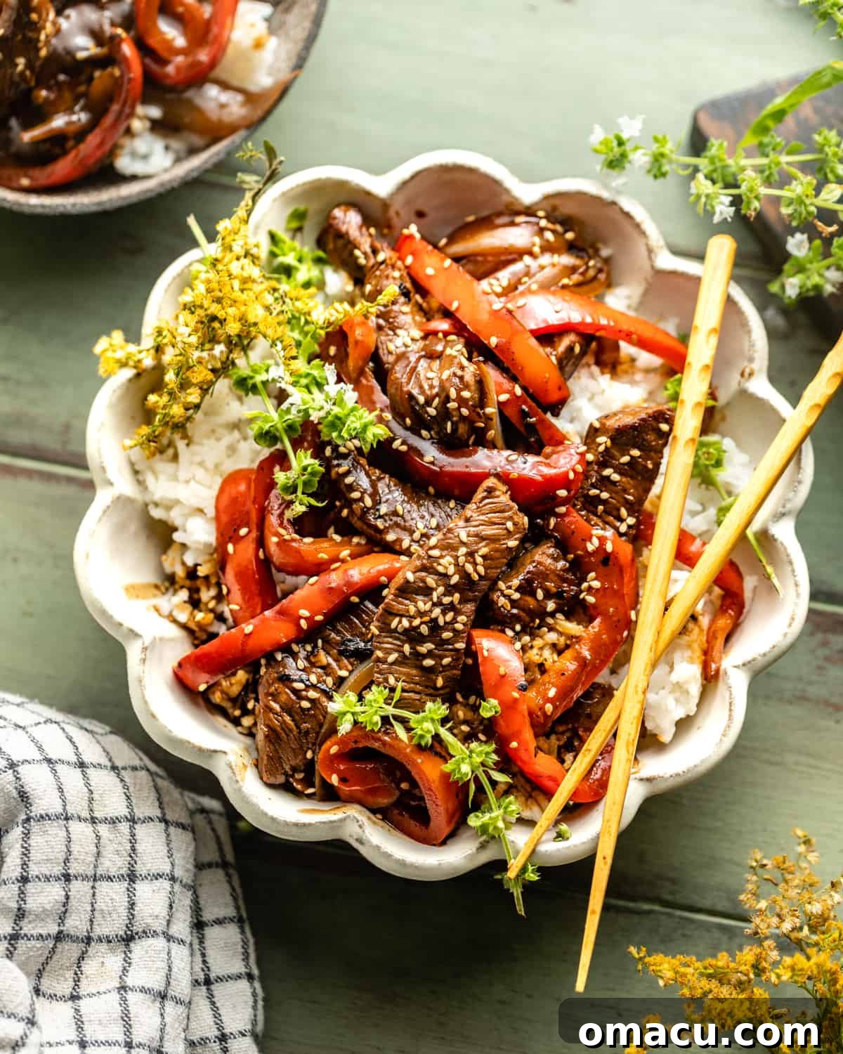 Pepper steak in a bowl with rice and bell peppers, ready to be served.