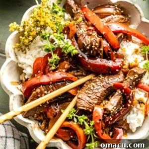 Pepper steak recipe in a bowl with chopsticks.