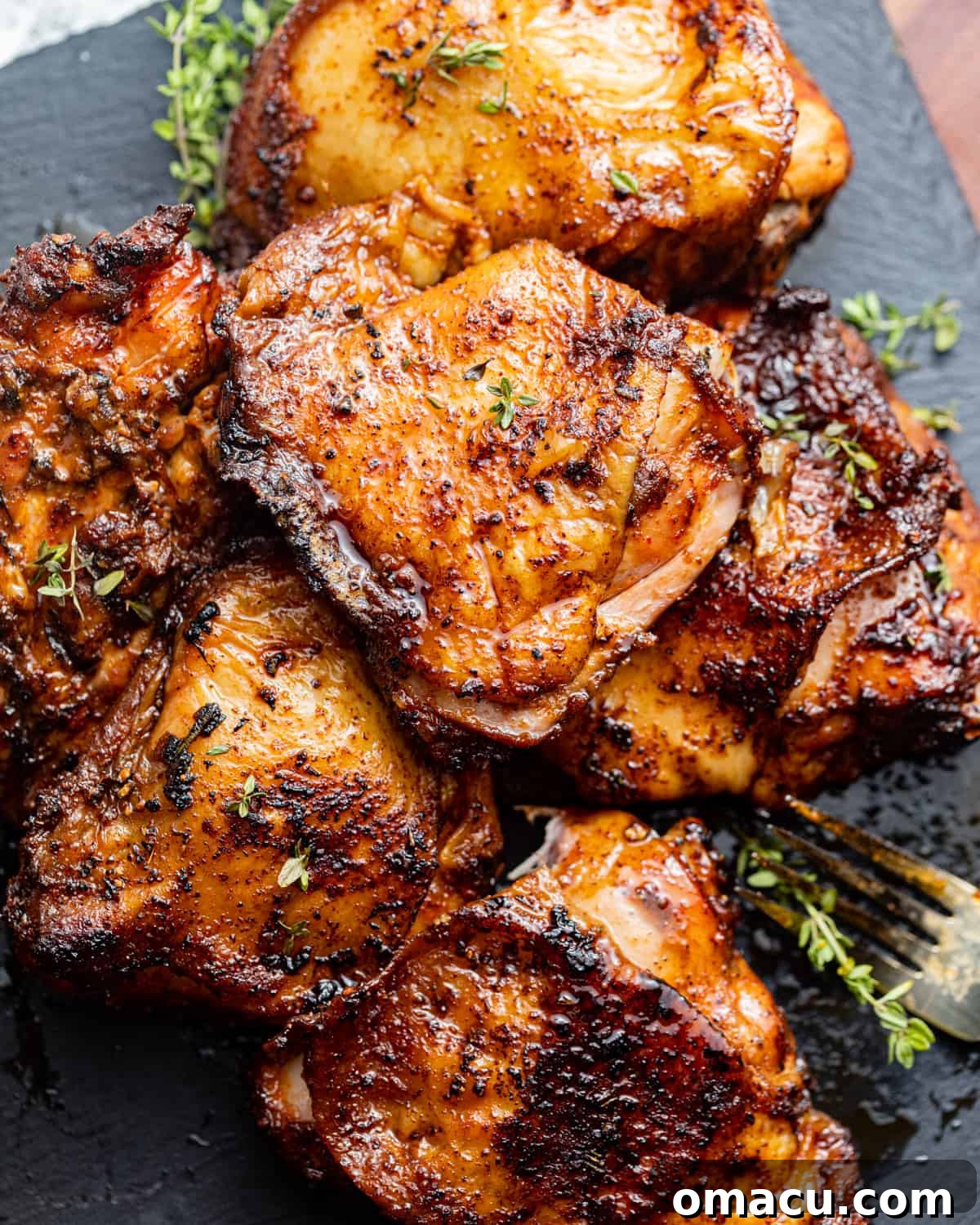 chicken thighs garnished with fresh herbs.