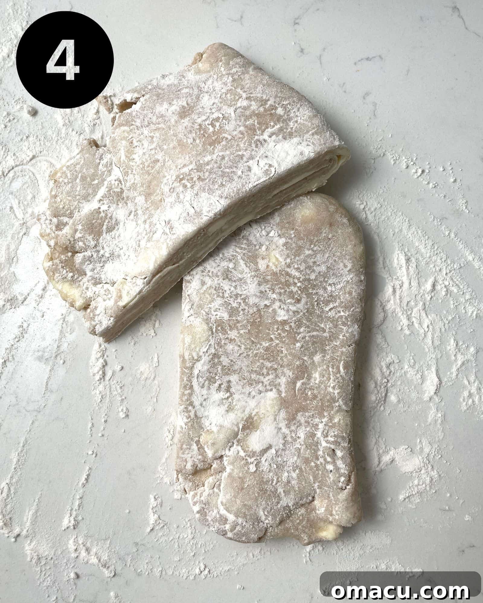 Two portions of pie dough divided and ready for rolling, demonstrating preparation for a double-crust pie.