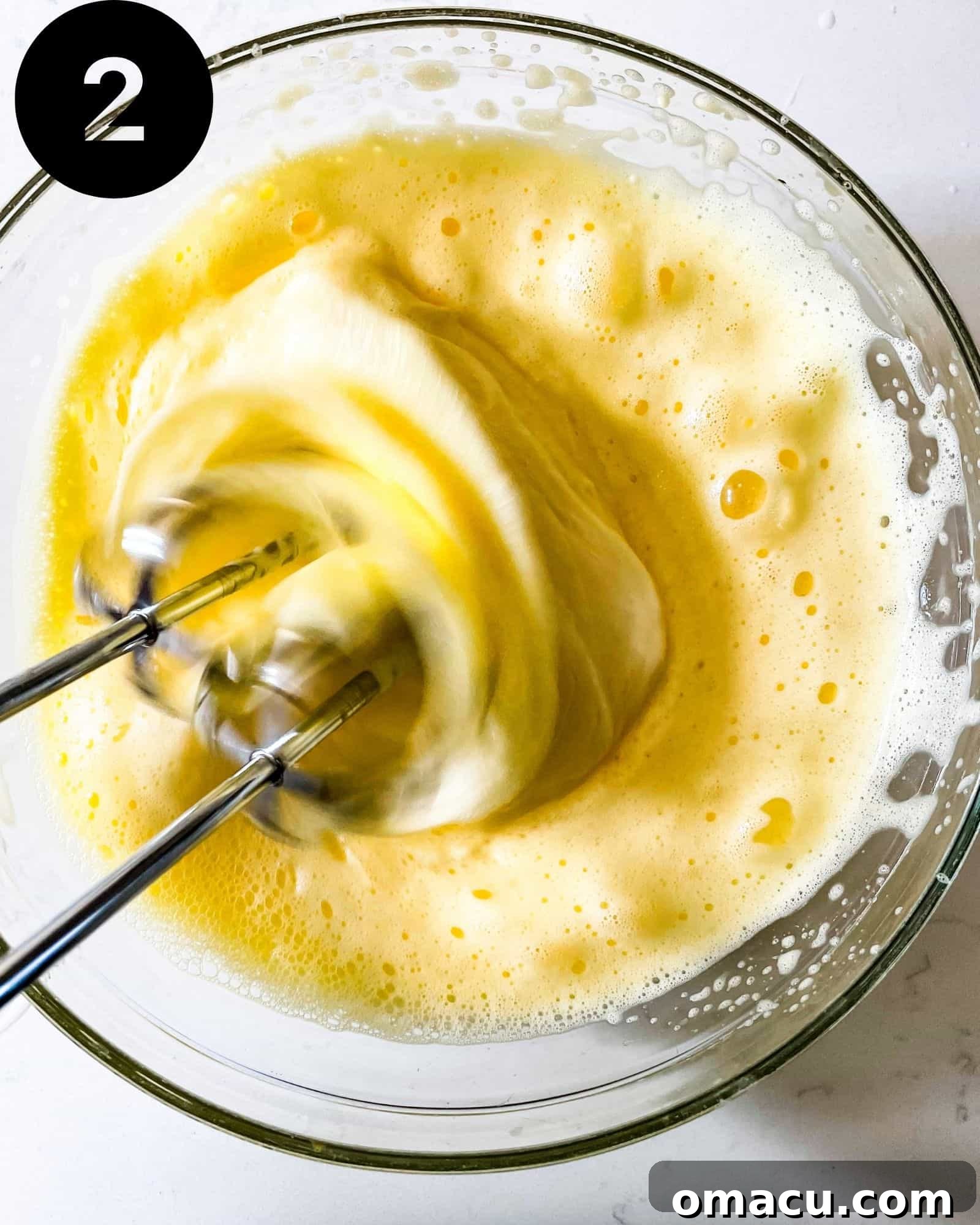 Wet ingredients (eggs, pumpkin puree, milk, and melted butter) mixed until frothy in a large mixing bowl.