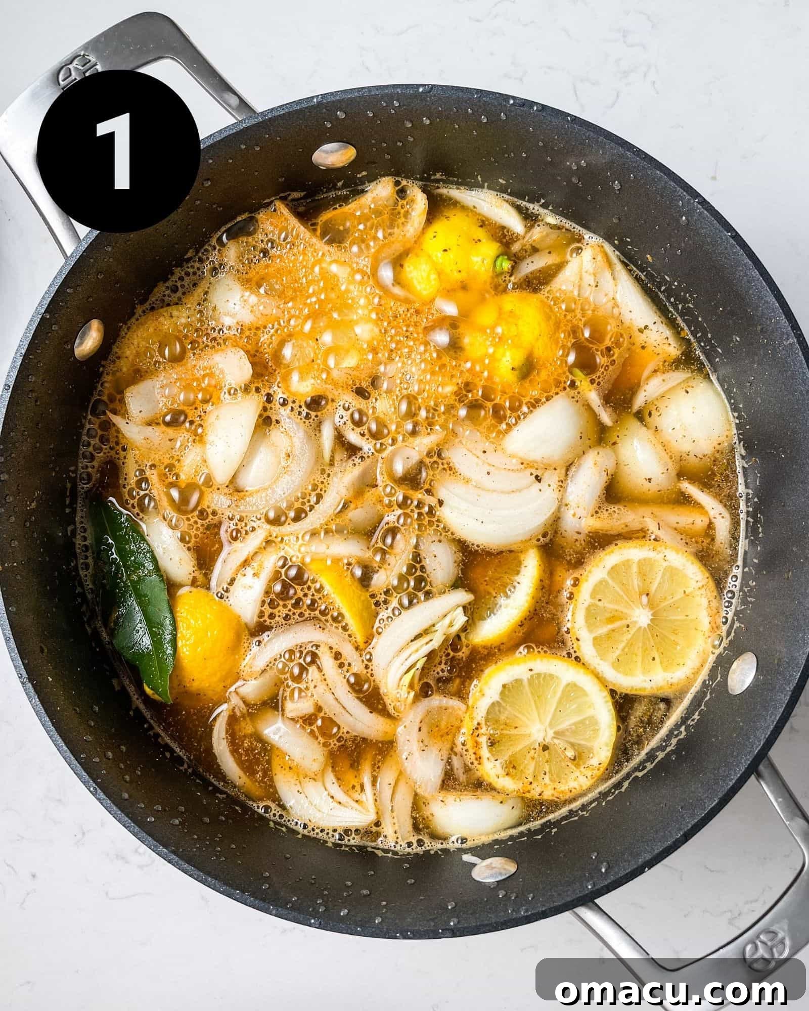 garlic, chicken broth, onions, lemons, bay leaves, and seasonings in a large pot.