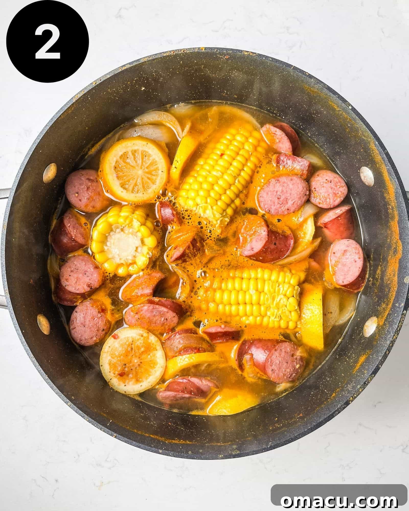potatoes, corn, sausage, and shrimp boil broth in a large pot.