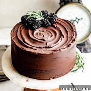 chocolate ganache cake on a cake stand.