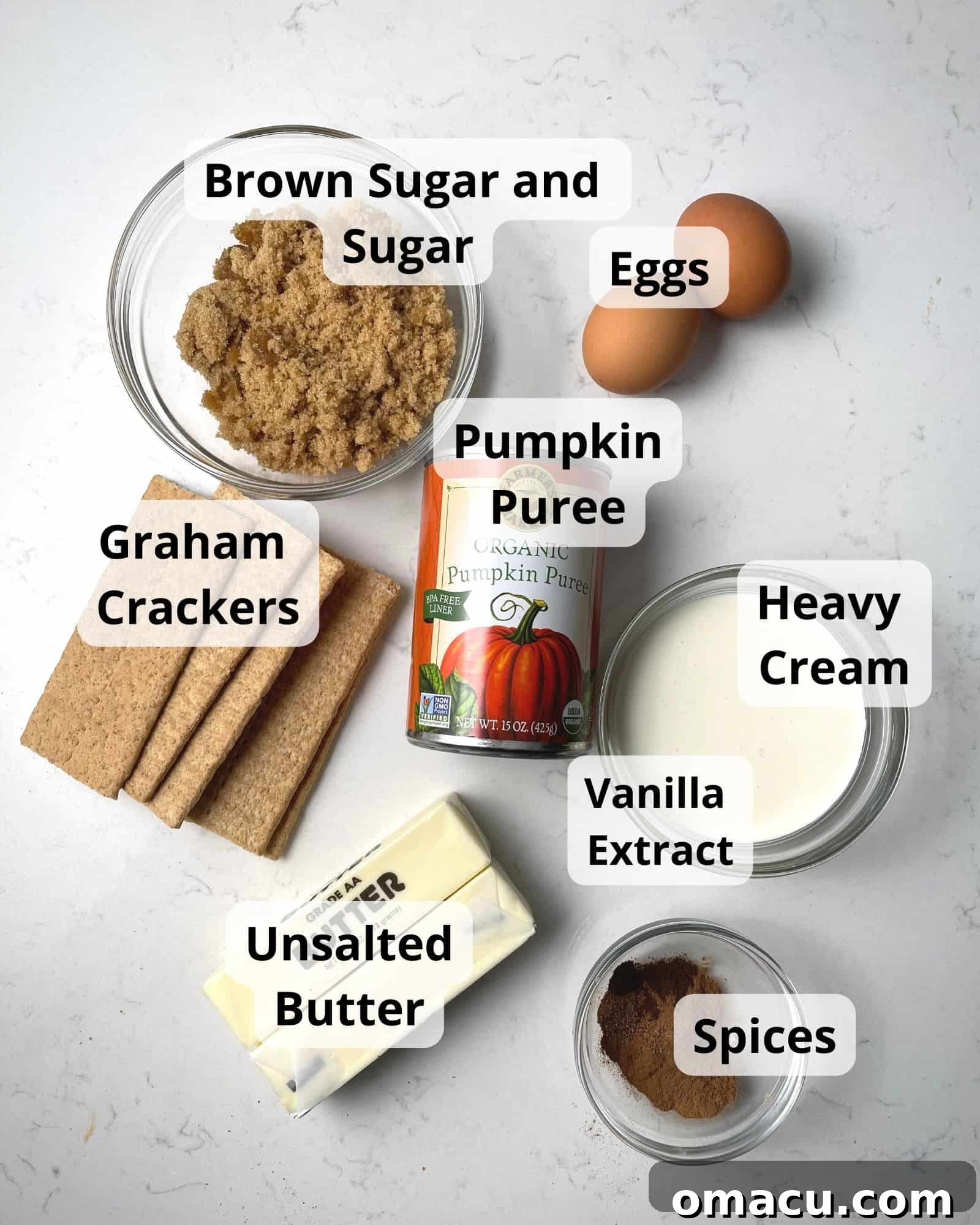 Ingredients to make pumpkin pie with graham cracker crust: brown sugar, granulated sugar, eggs, pumpkin puree, heavy cream, vanilla extract, unsalted butter, mixed spices, and graham crackers laid out.