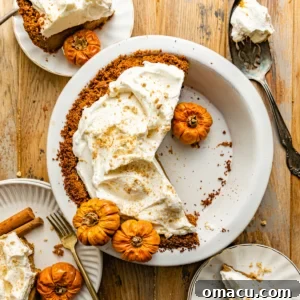 a pumpkin pie with graham cracker crust in a pie dish.