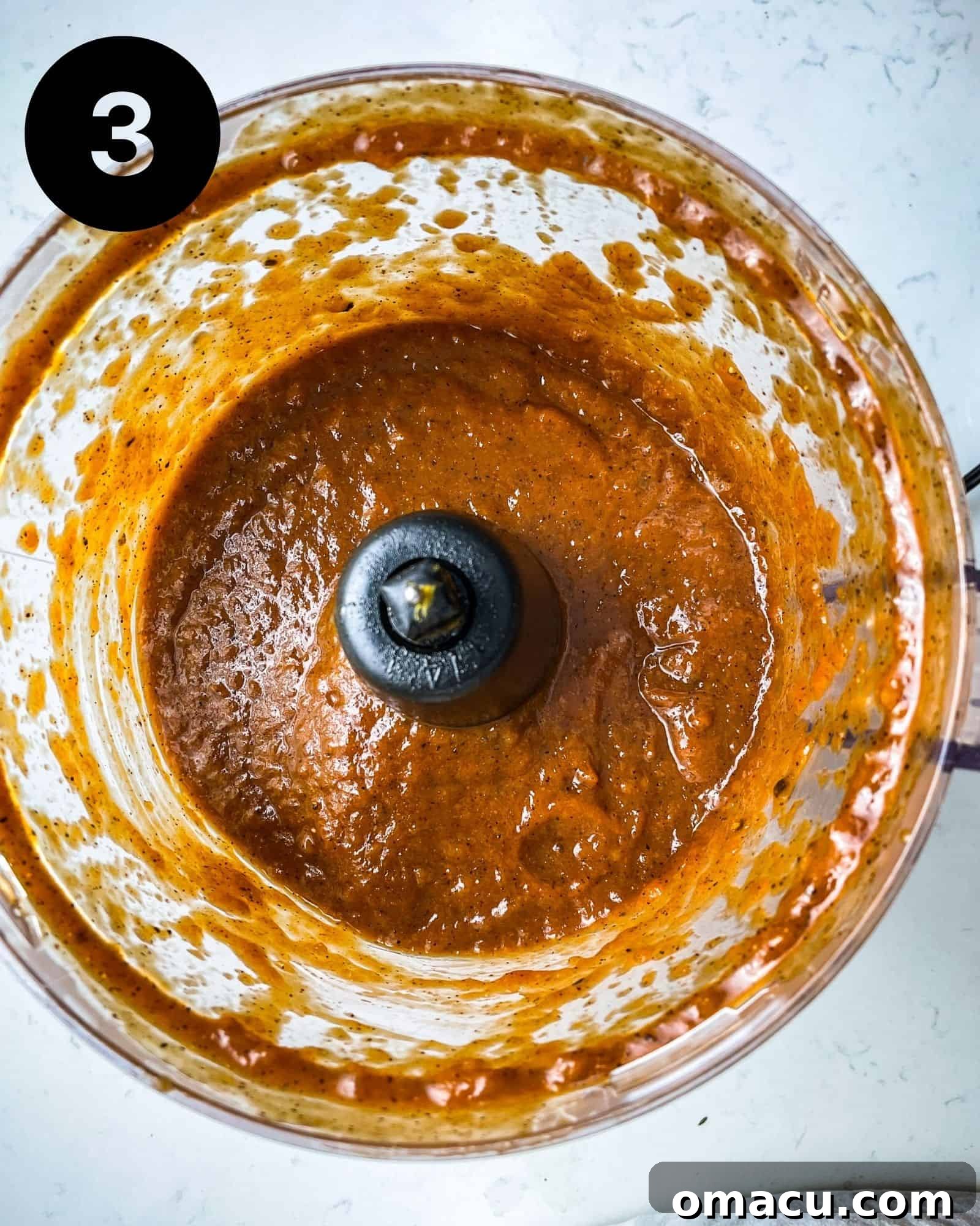 The honey bbq sauce being blended in a food processor until smooth and uniform.
