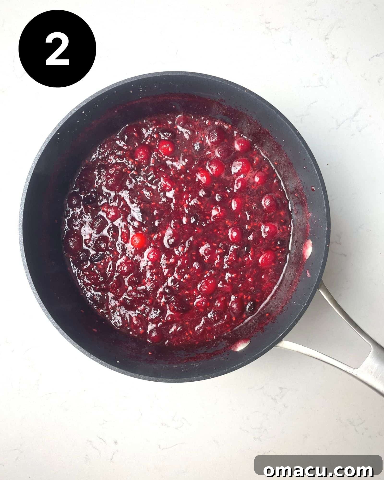 The finished cranberry raspberry sauce in a saucepan, thickened and ready for the final step.