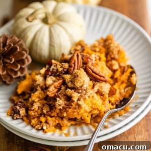 A vibrant close-up of the finished Bourbon Sweet Potato Casserole, ready to be served, highlighting the golden pecan streusel.
