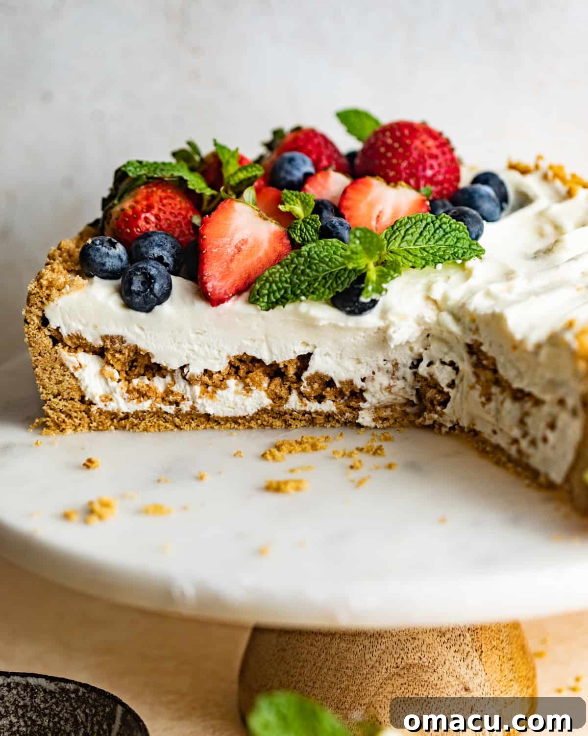 A beautiful Philadelphia No-Bake Cheesecake presented on a cake stand, ready to be served and enjoyed.