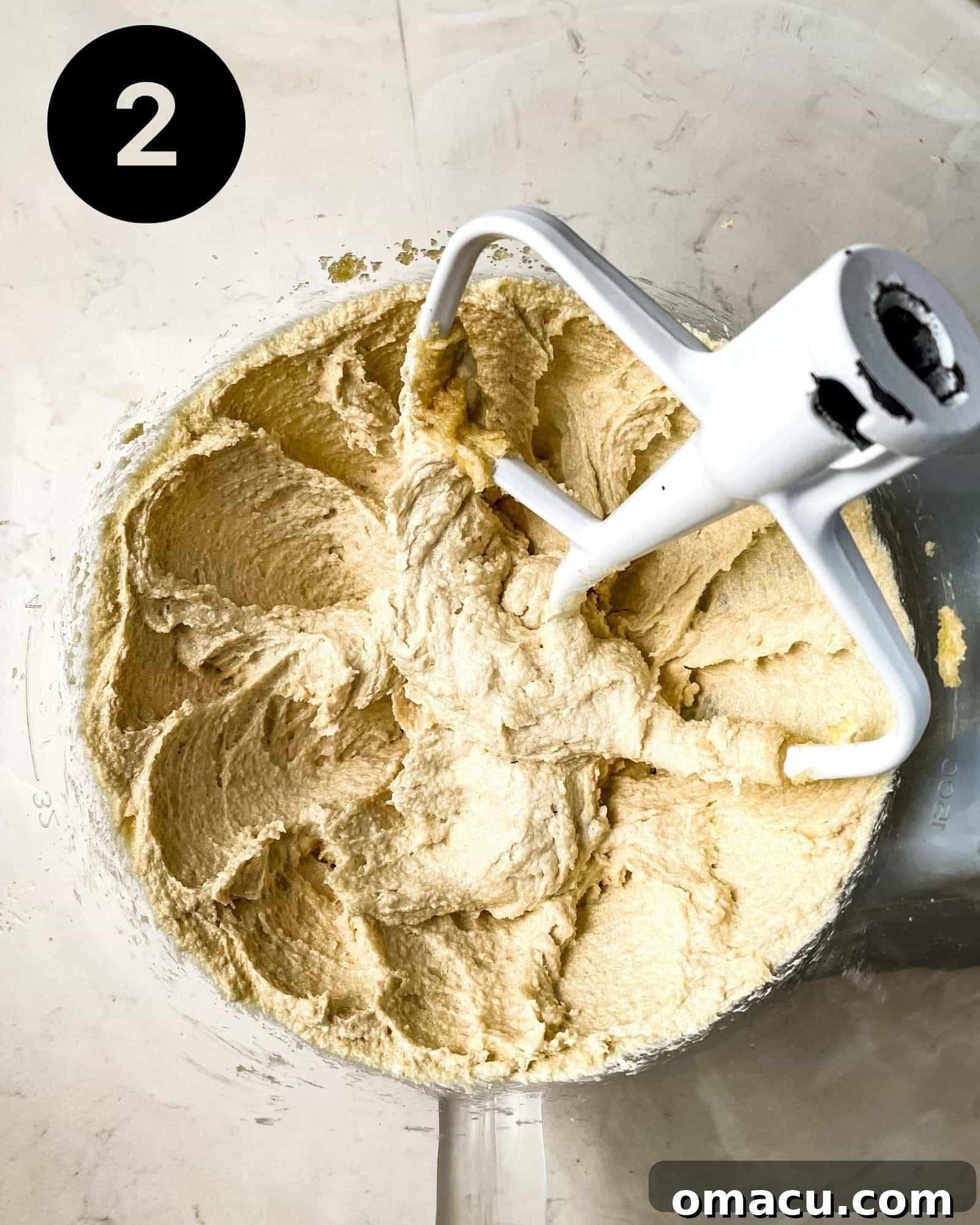 Room temperature butter, brown sugar, and granulated sugar creamed together in a stand mixer bowl, appearing light and fluffy.