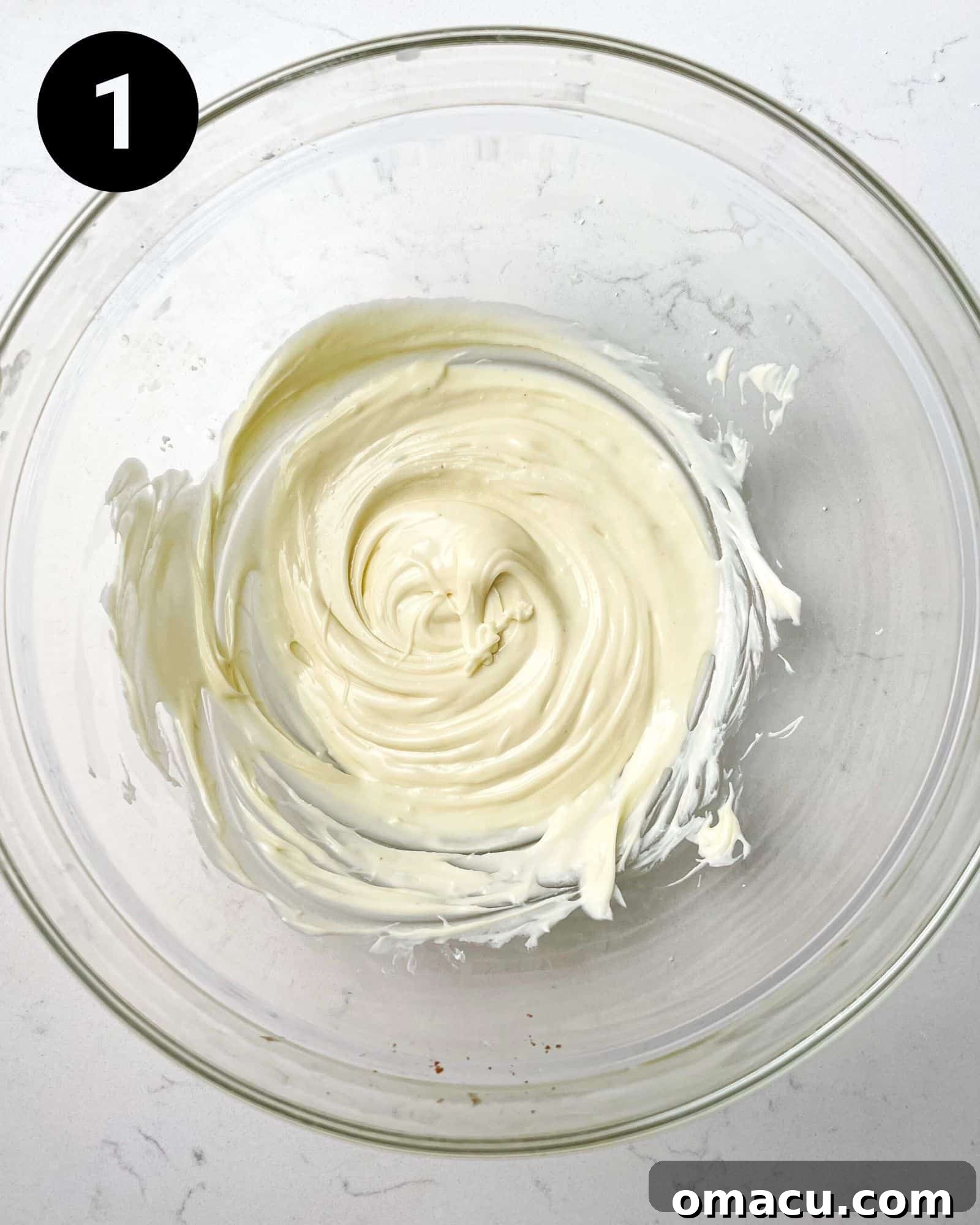 A bowl of freshly melted white chocolate, smooth and ready for the next step in the filling preparation.