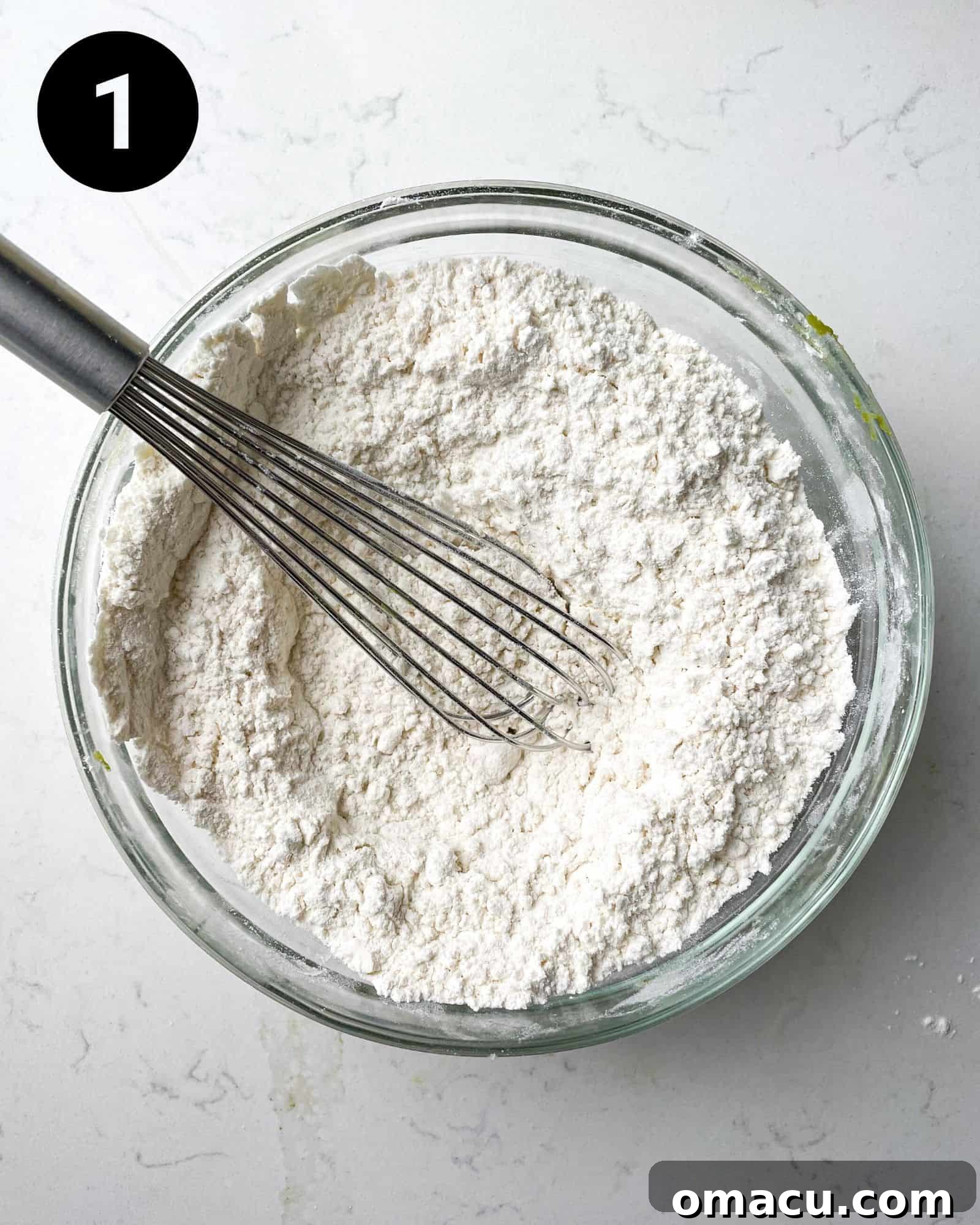 Dry ingredients for chocolate chip sugar cookies – flour, cornstarch, baking powder, baking soda, and salt – perfectly mixed in a large bowl.