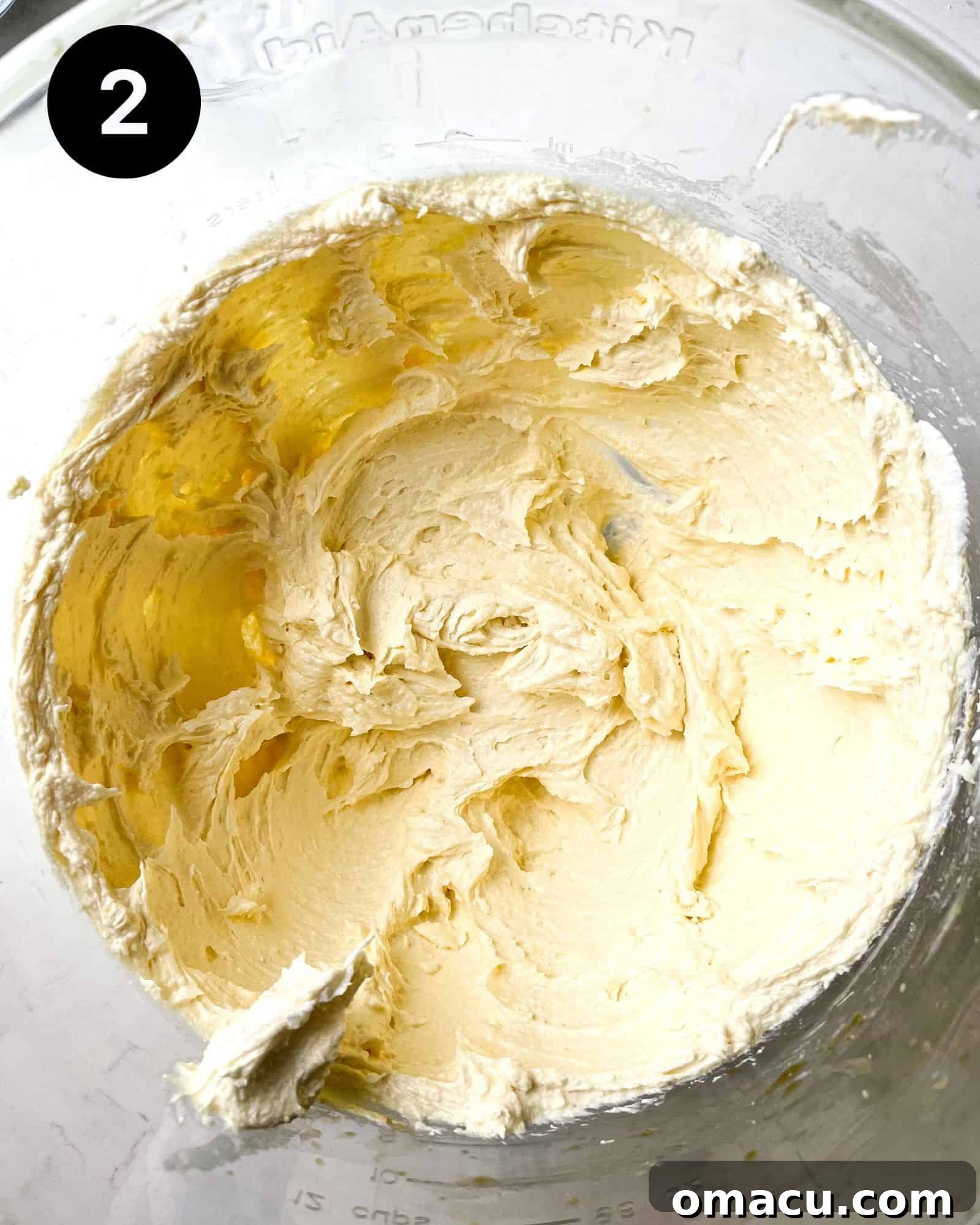 Softened butter and granulated sugar beautifully creamed together in a stand mixer bowl, forming a light and fluffy mixture.