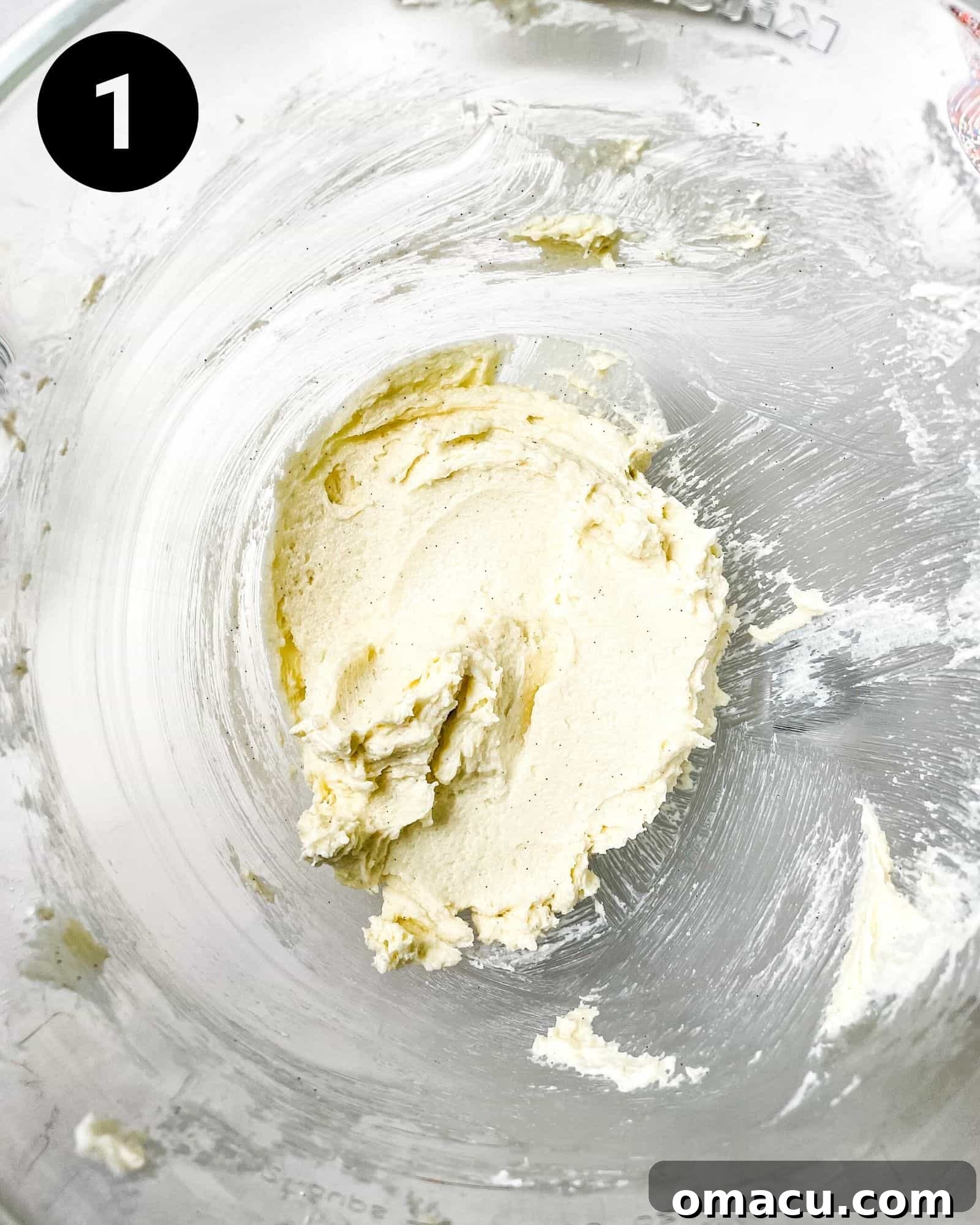 Softened butter and granulated sugar being creamed together in a stand mixer bowl, showing the light and fluffy texture as they combine.