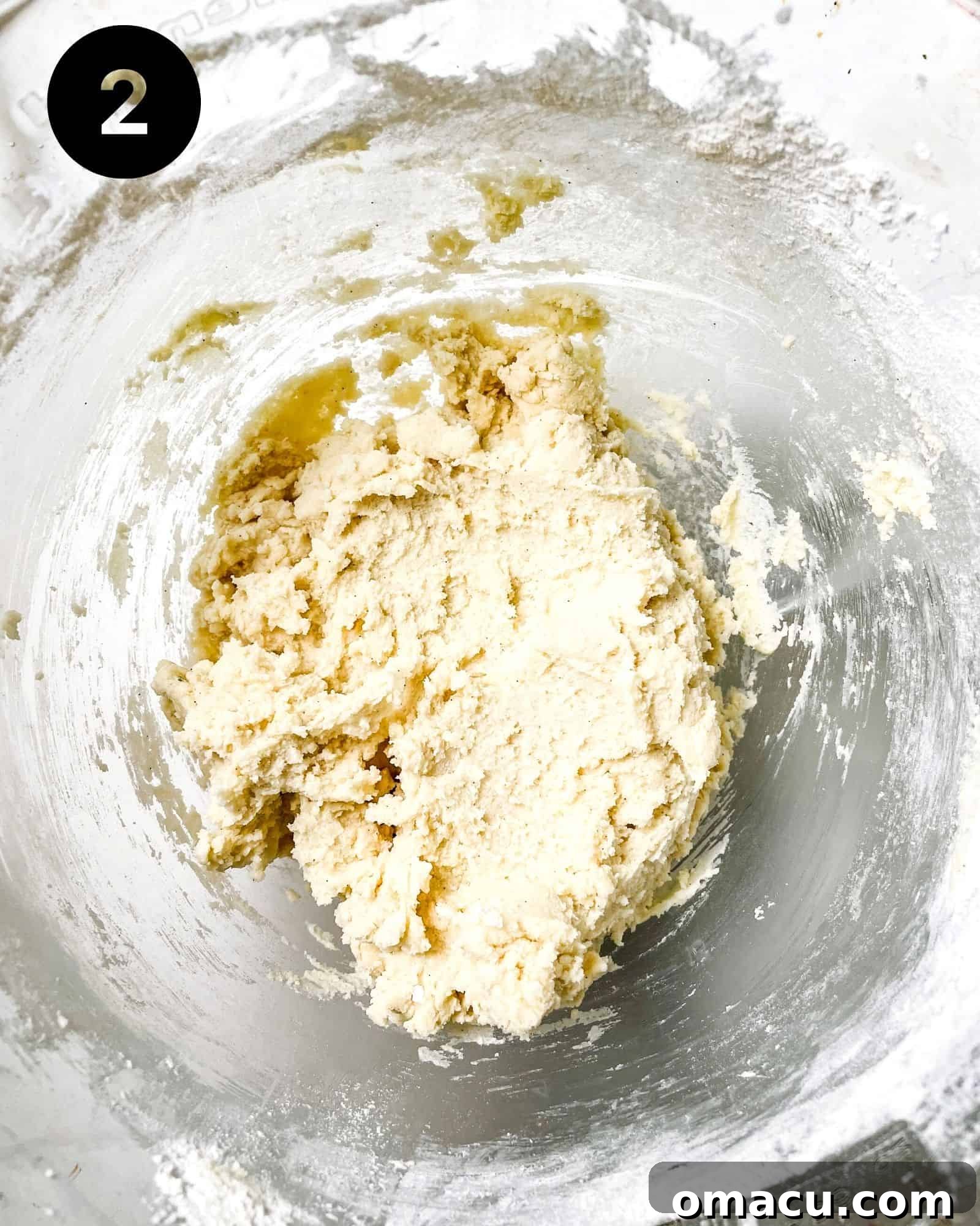 A mixing bowl filled with freshly prepared sprinkle cookie dough, showcasing its smooth texture and readiness for shaping.