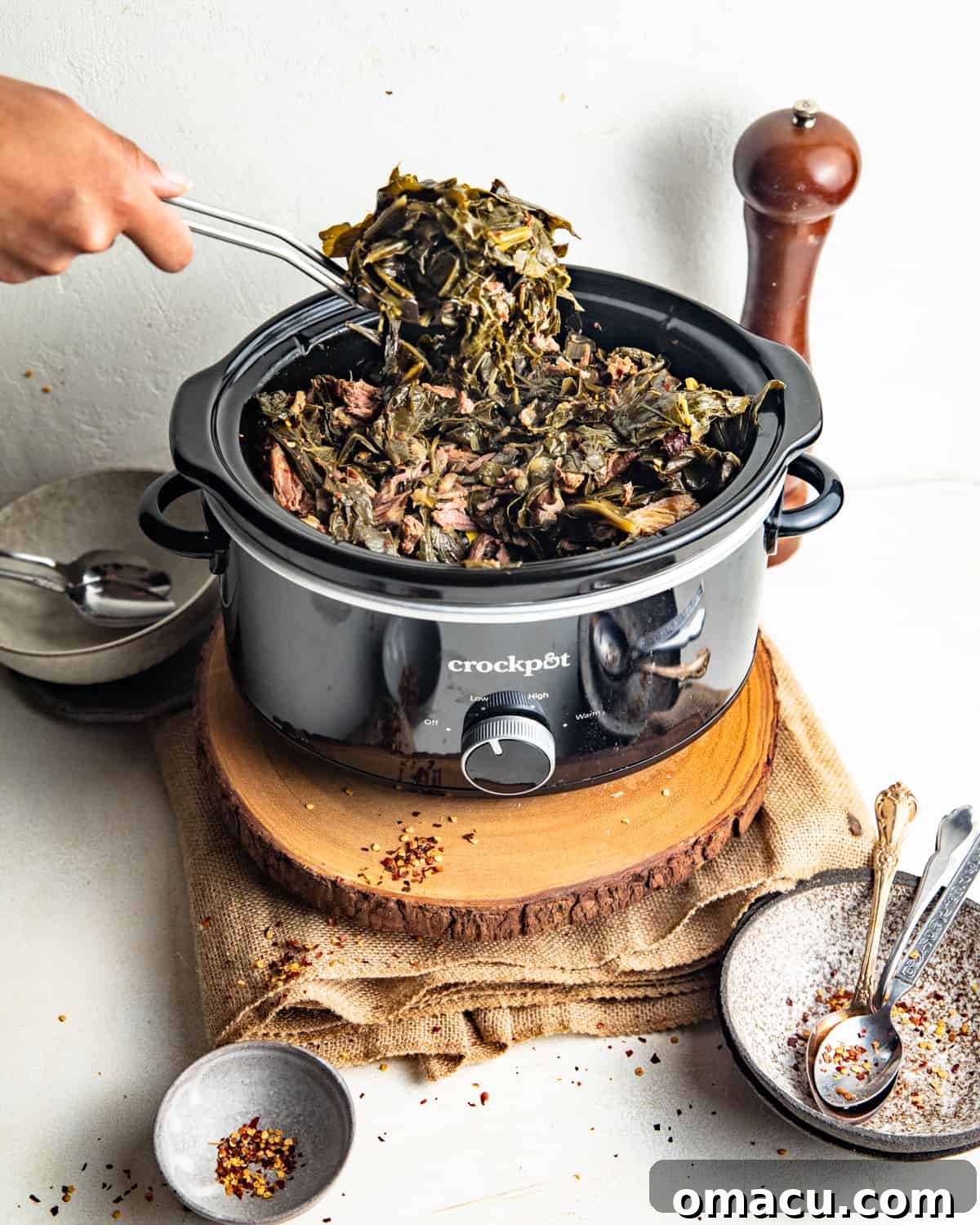 Collard greens simmering gently in a slow cooker.