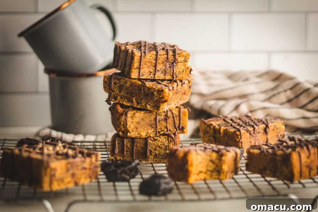 Gooey Miso Prune Blondies with elegant chocolate drizzle, showcasing a perfect blend of sweet and salty flavors.