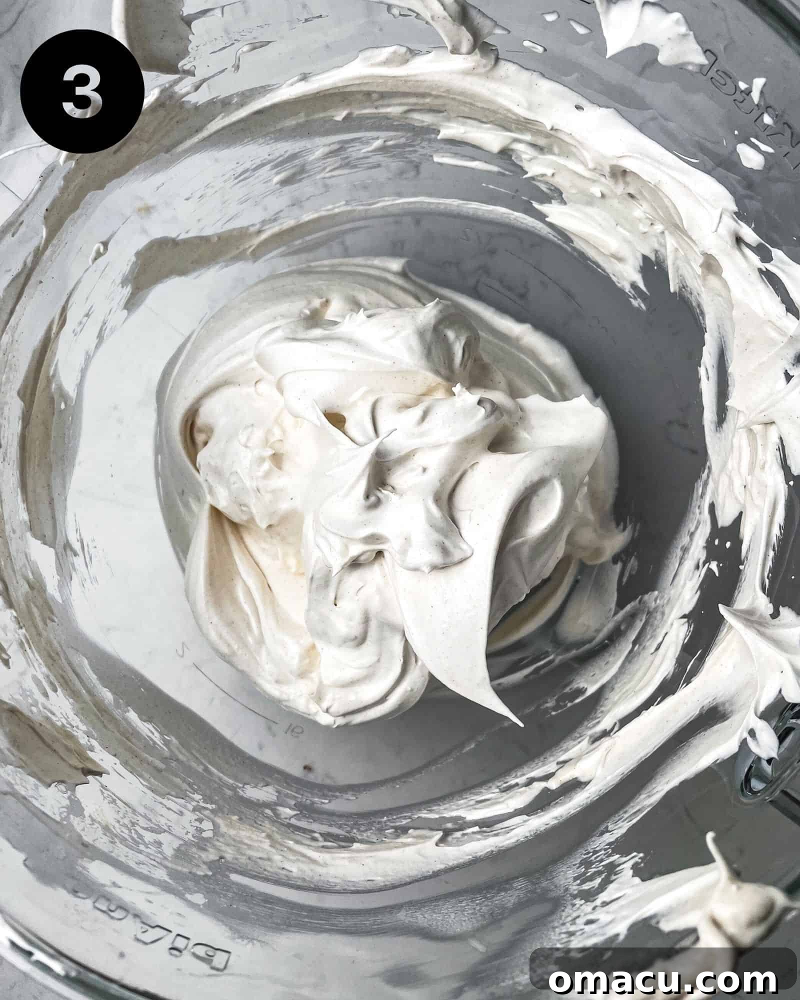glossy meringue in a bowl, beaten to stiff peaks, ready for macaronage.