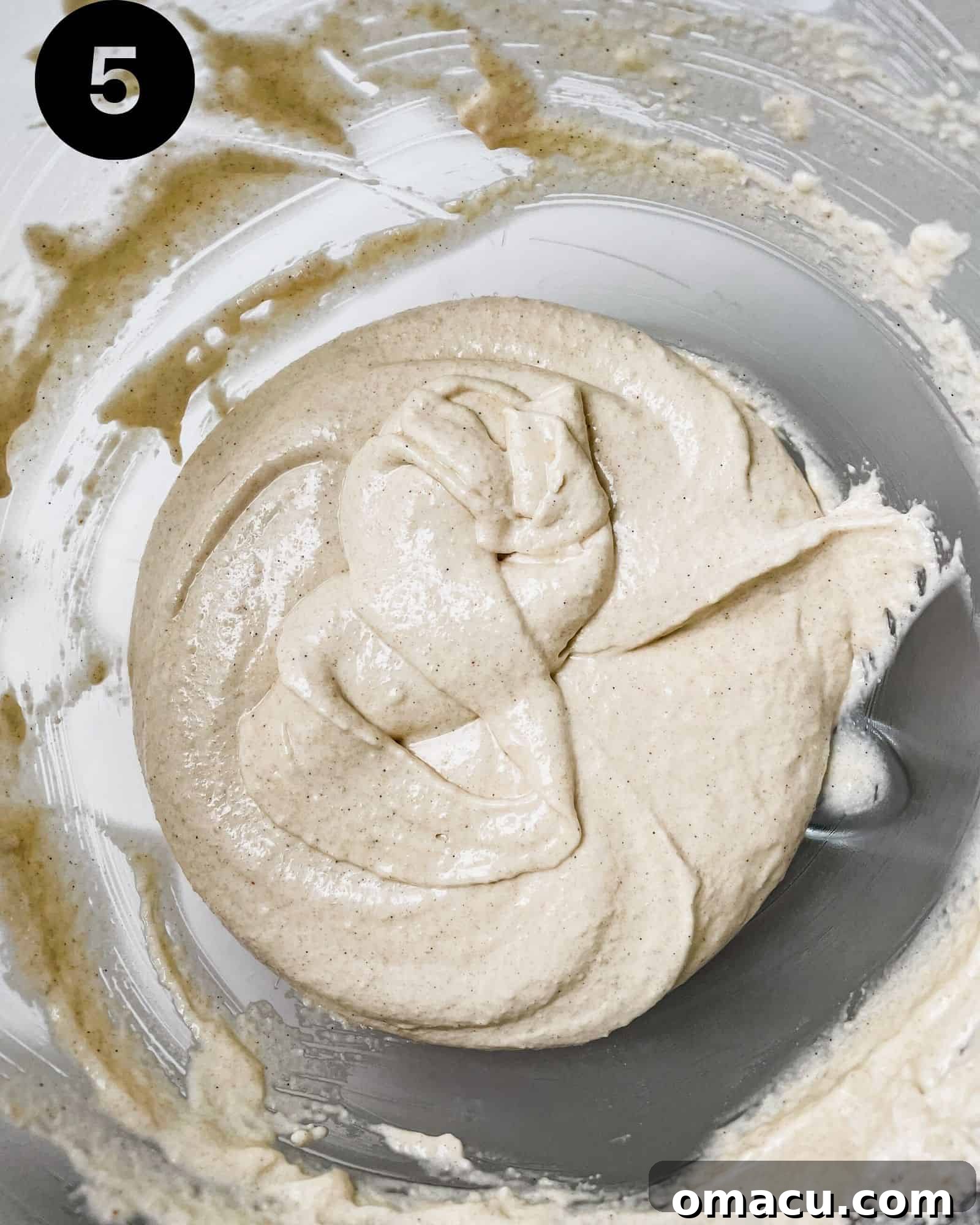 perfectly mixed macaron batter with a lava-like consistency in a mixing bowl.