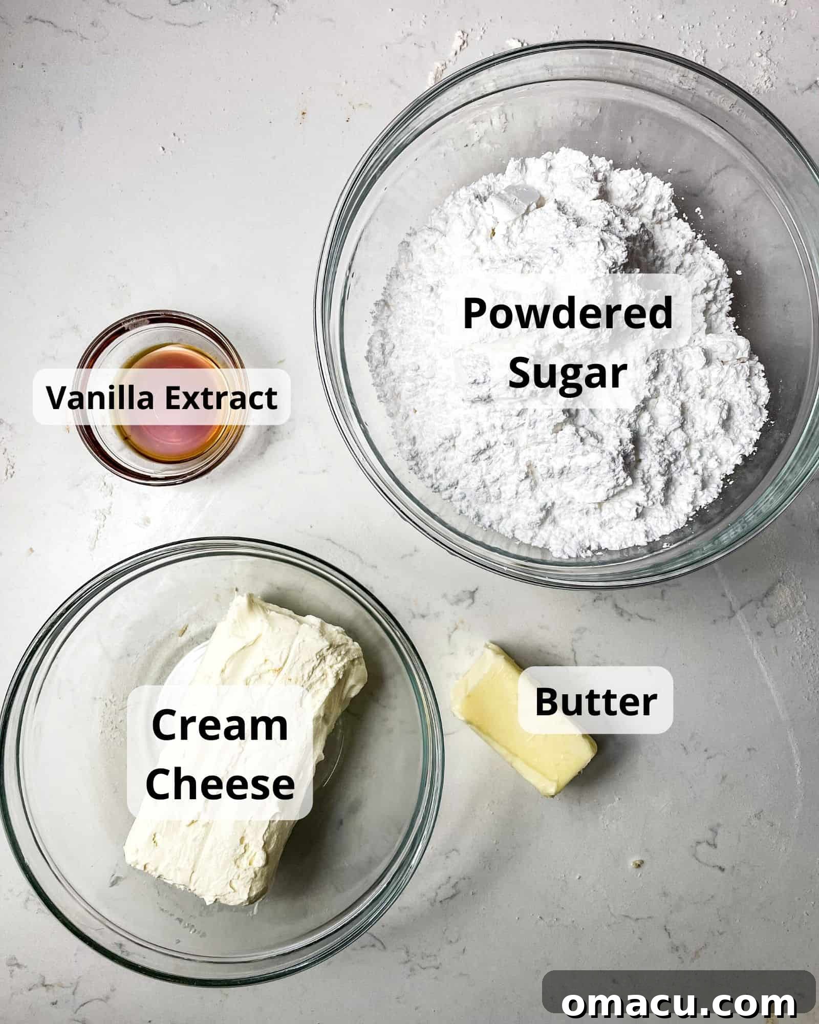 Ingredients for making the perfect cream cheese icing: softened cream cheese, butter, powdered sugar, and vanilla extract.