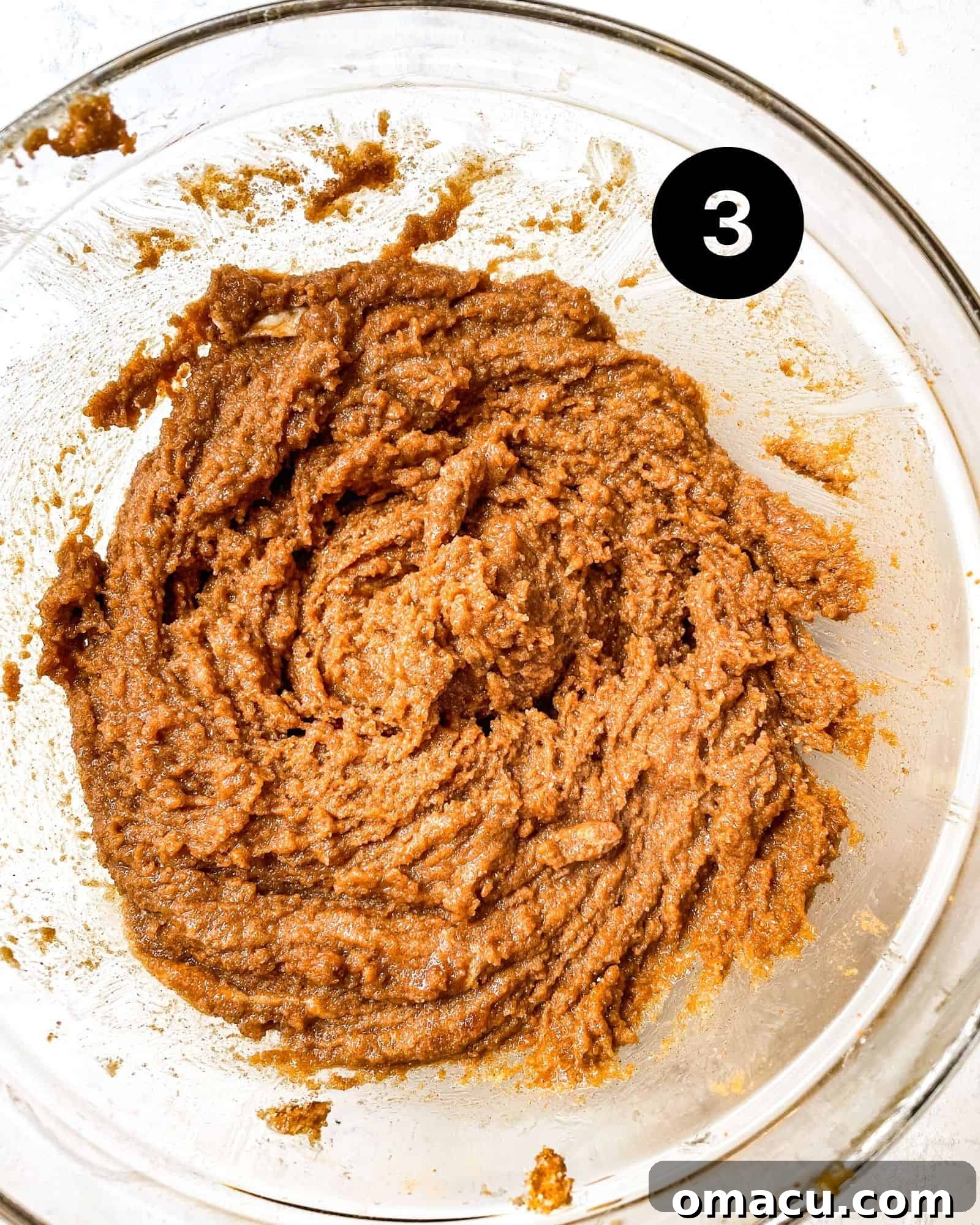 The cinnamon roll filling mixture, a rich blend of brown sugar, granulated sugar, cinnamon, and butter, prepared in a bowl.
