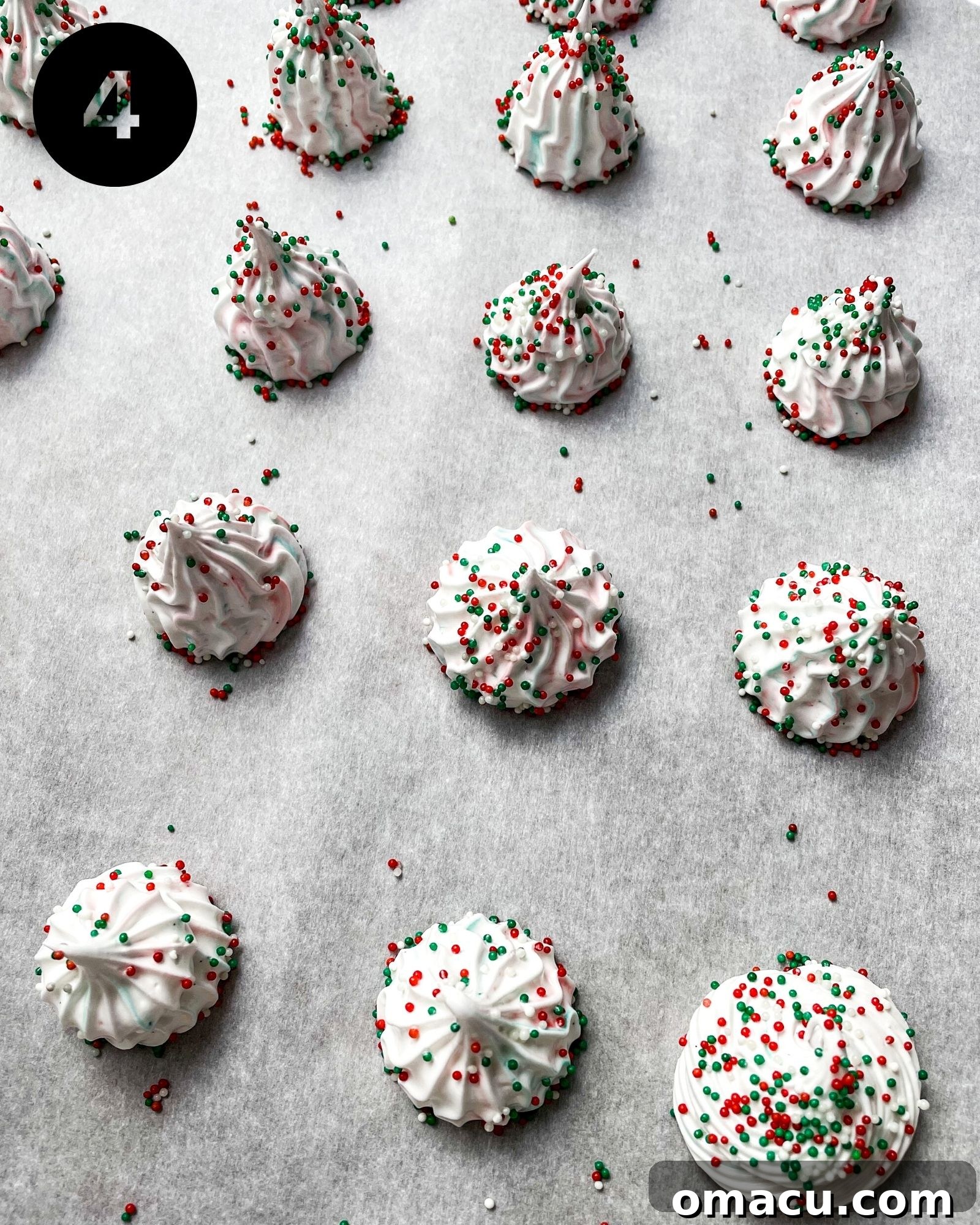 meringue cookies on a baking sheet. Rows of perfectly piped, unbaked meringue cookies, arranged neatly on a parchment-lined baking sheet, ready for slow baking and drying.