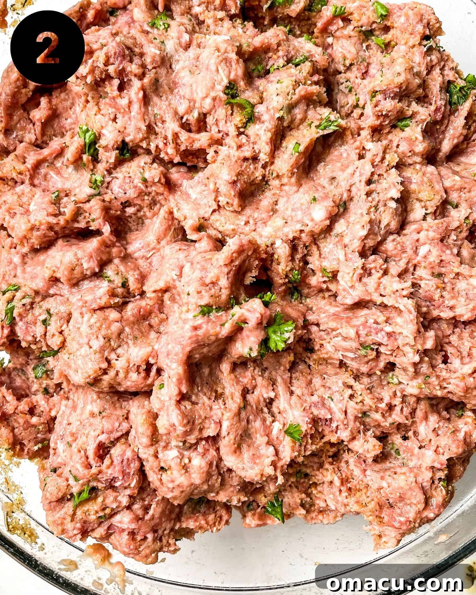 ground beef and seasonings mixed together in a bowl.