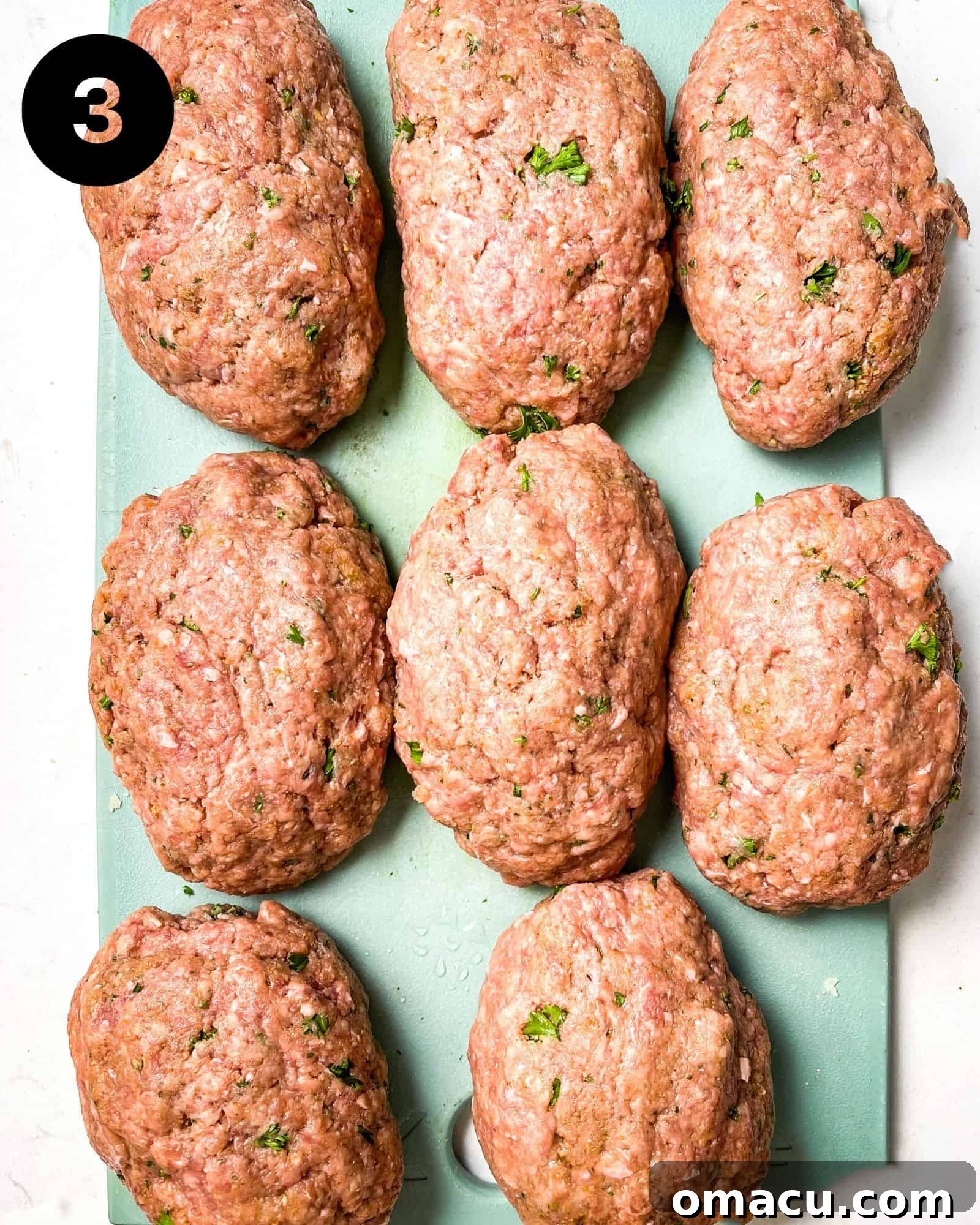 uncooked salisbury steaks on a cutting board.