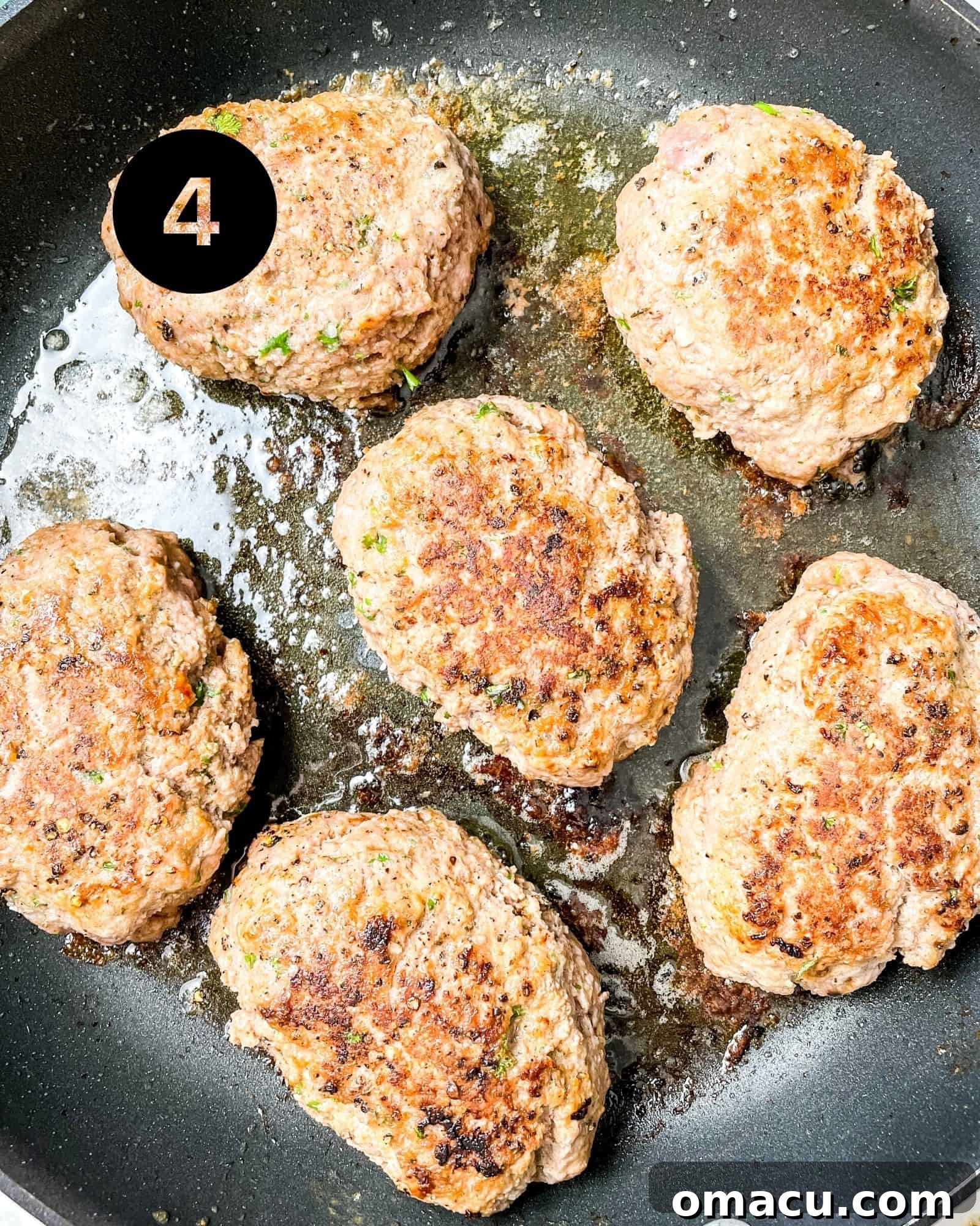 hamburger steaks in a skillet with olive oil and butter.