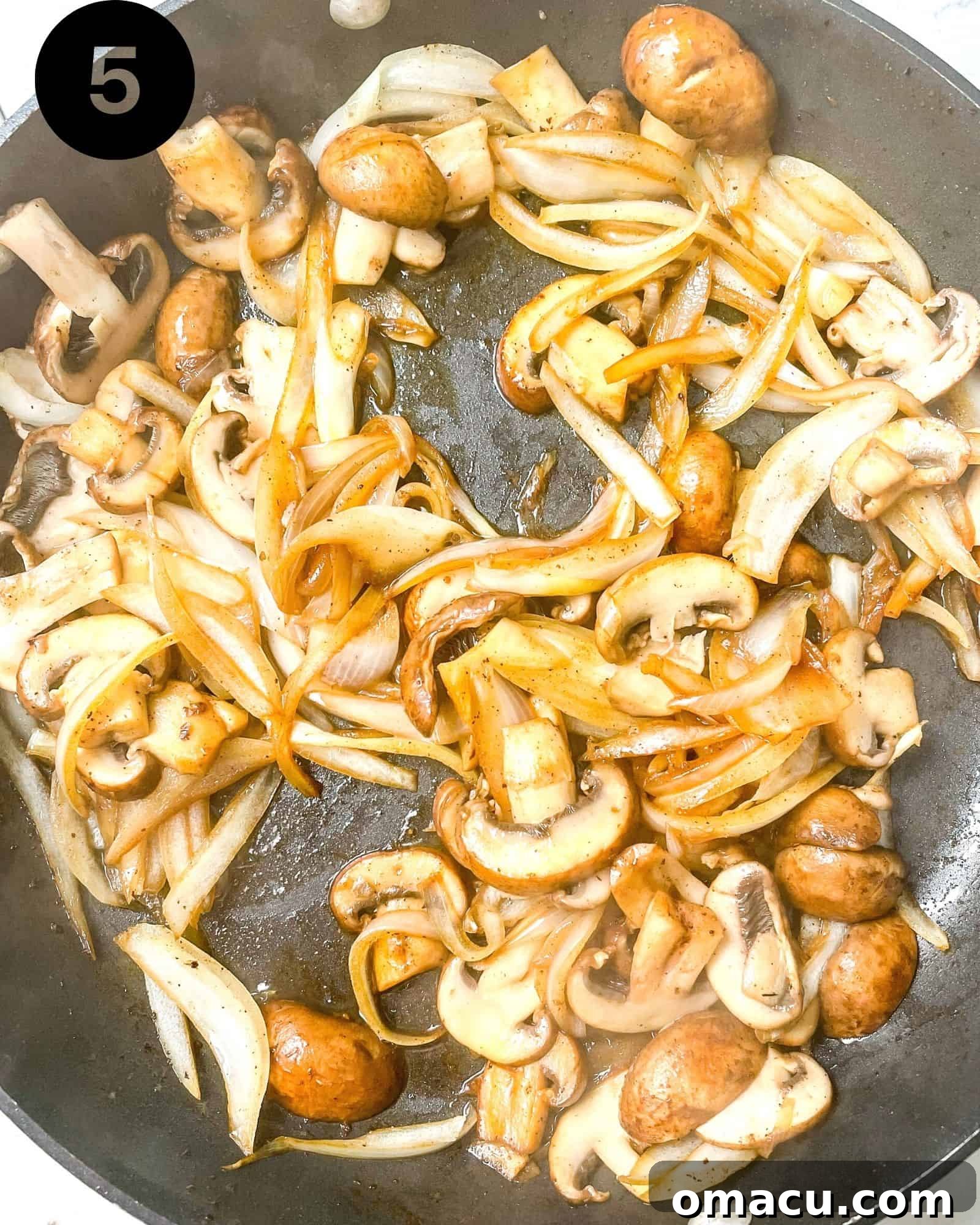 mushroom and onions sauteed in a skillet.