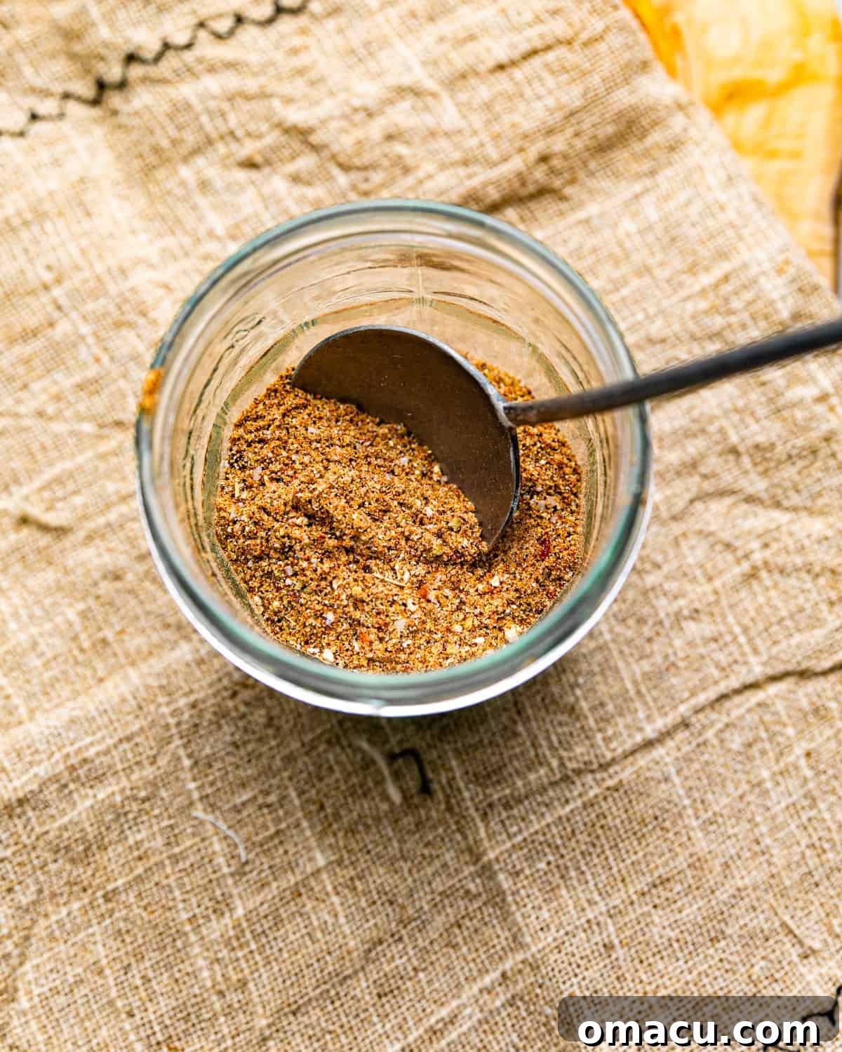 chicken taco seasoning in a mason jar with a spoon.
