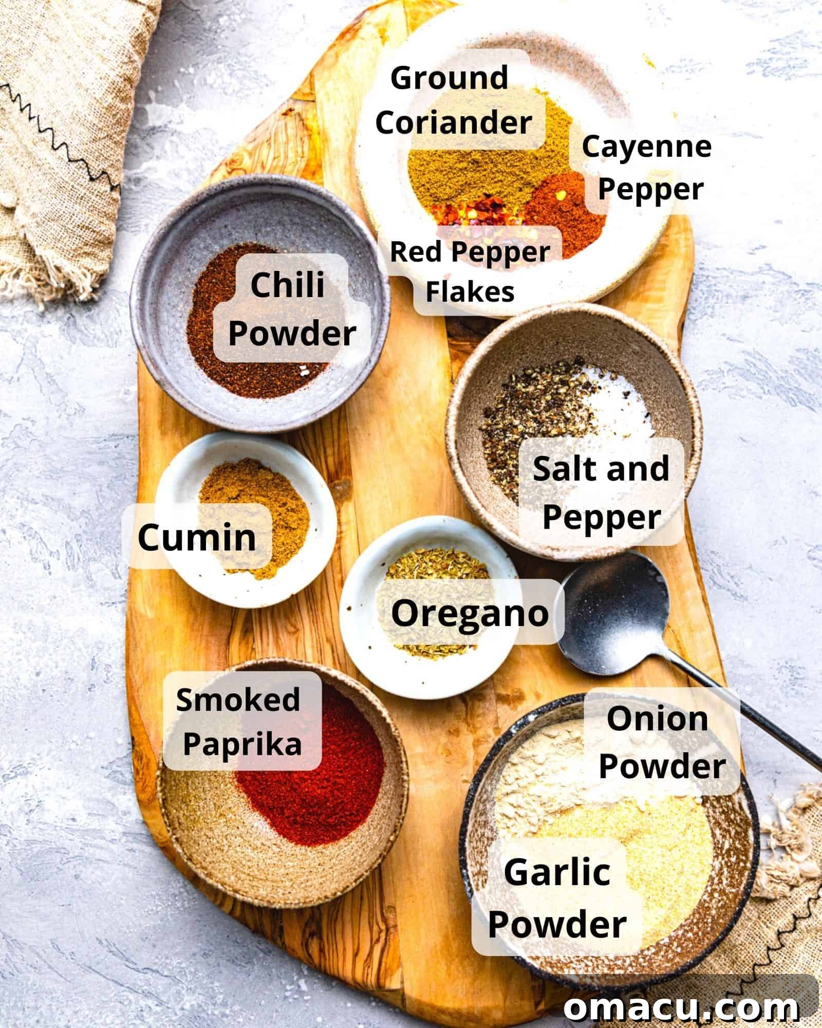 ingredients to make chicken taco seasoning - ground coriander, red pepper flakes, cayenne pepper, smoked paprika, oregano, chili powder, salt, pepper, garlic powder, and onion powder.