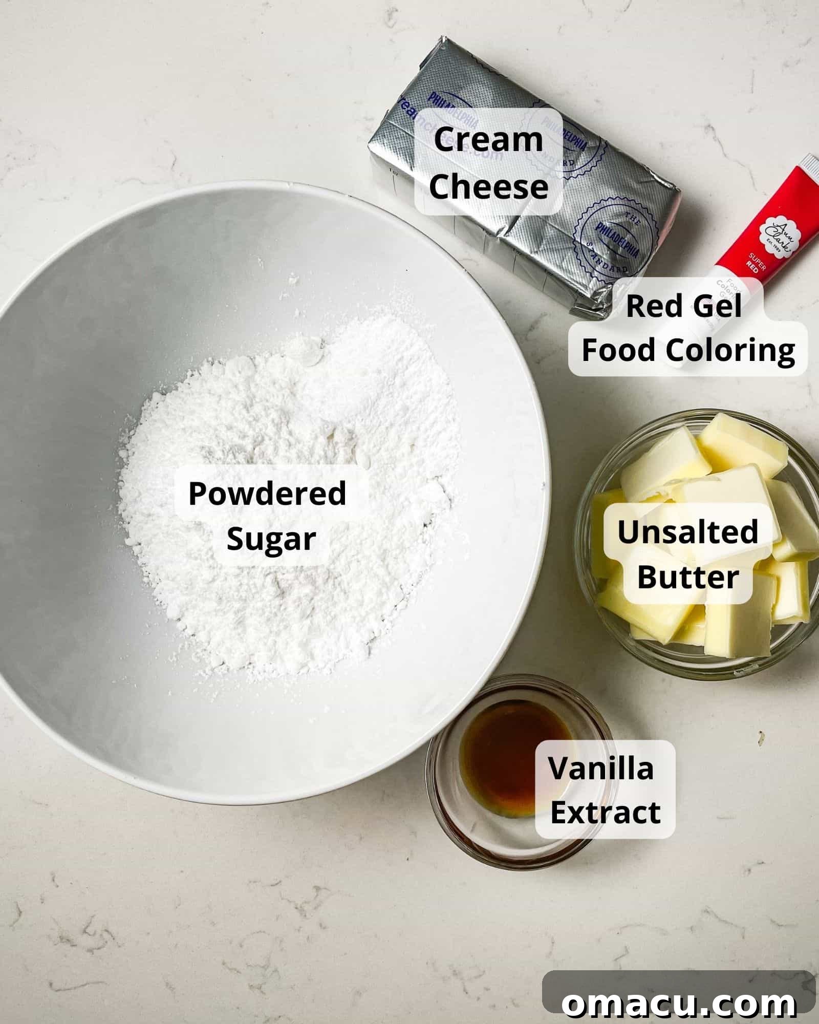 Ingredients for a luscious cream cheese frosting: powdered sugar, softened cream cheese, unsalted butter, vanilla extract, and optional red food coloring, arranged for preparation.