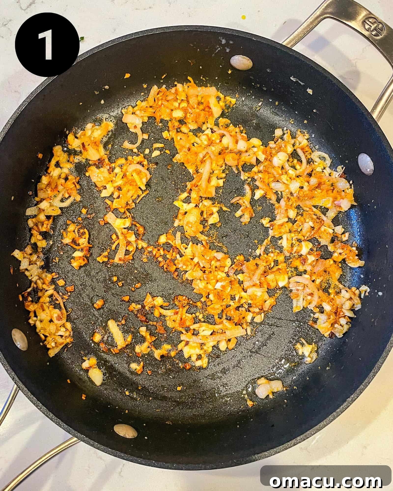 A close-up shot of diced shallots, minced garlic, and bright yellow lemon zest gently sautéing in a large skillet, creating an aromatic base for the pasta sauce.