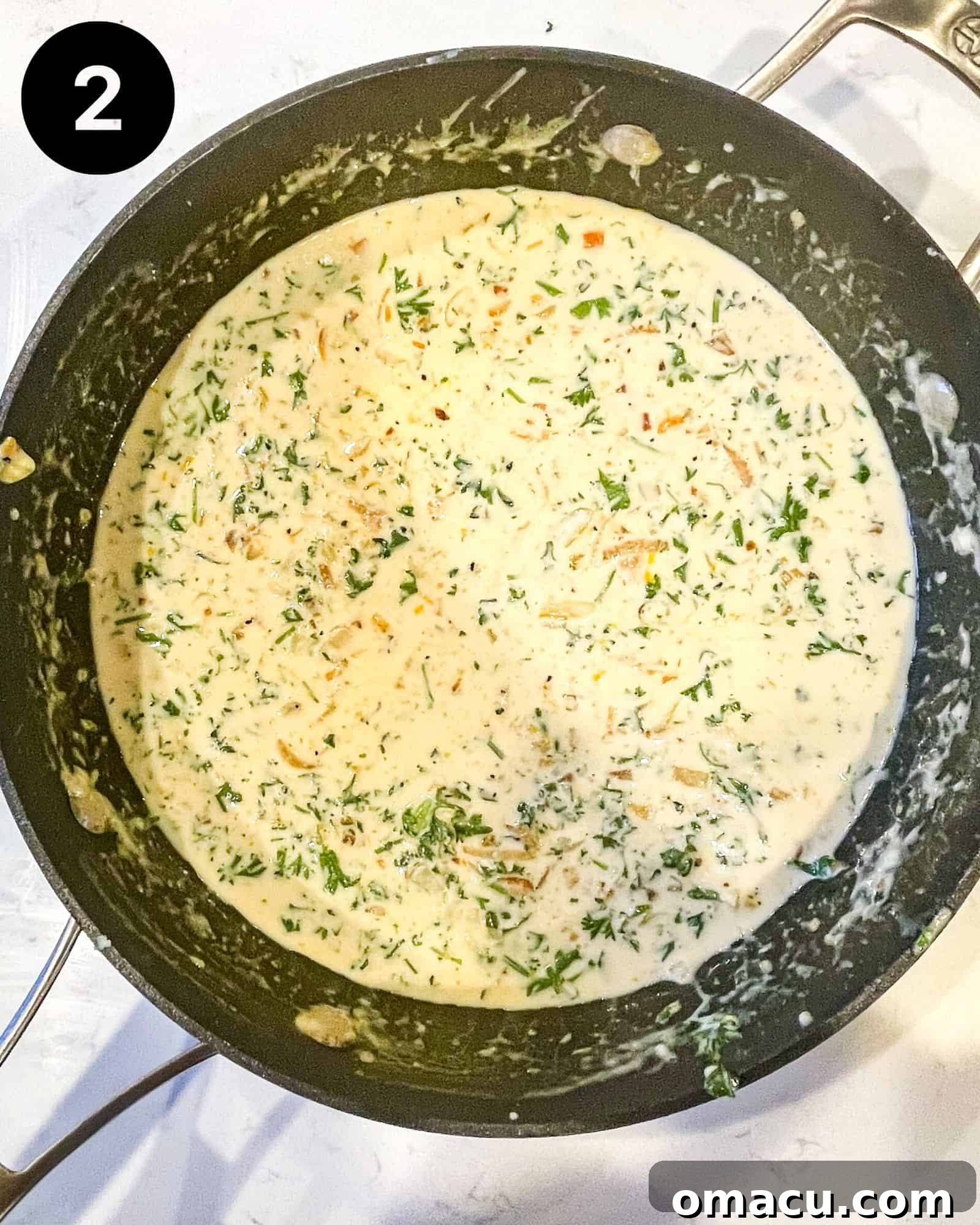 A creamy lemon garlic pasta sauce simmering in a skillet, with fresh lemon juice being added and vibrant green fresh parsley stirred in, completing the sauce.