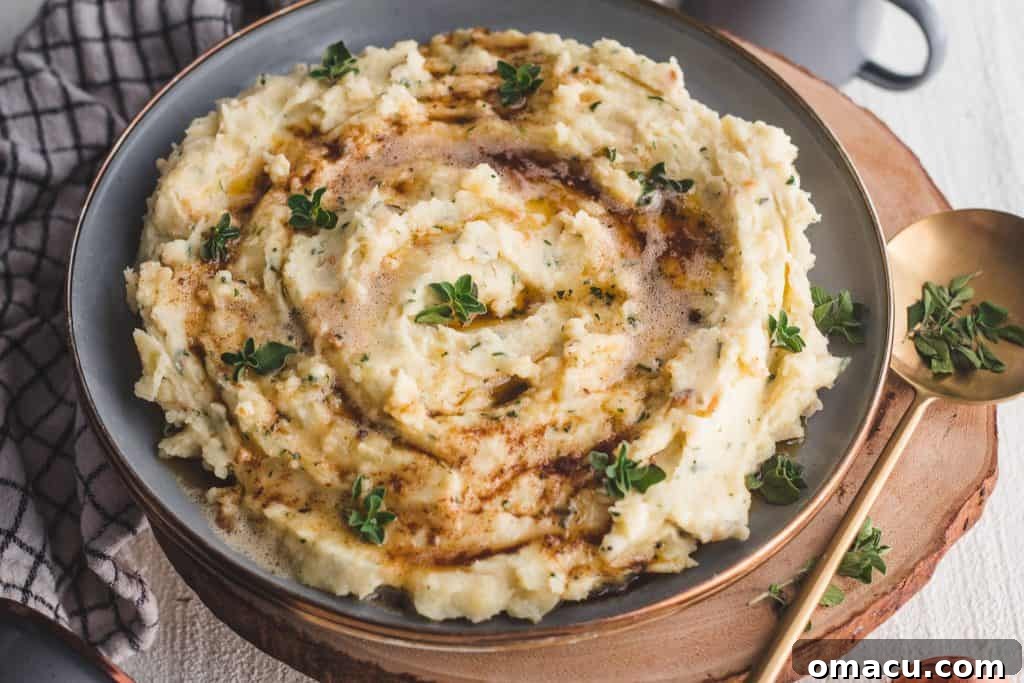 Creamy Brown Butter and Herb Mashed Potatoes, garnished with fresh herbs in a serving bowl.