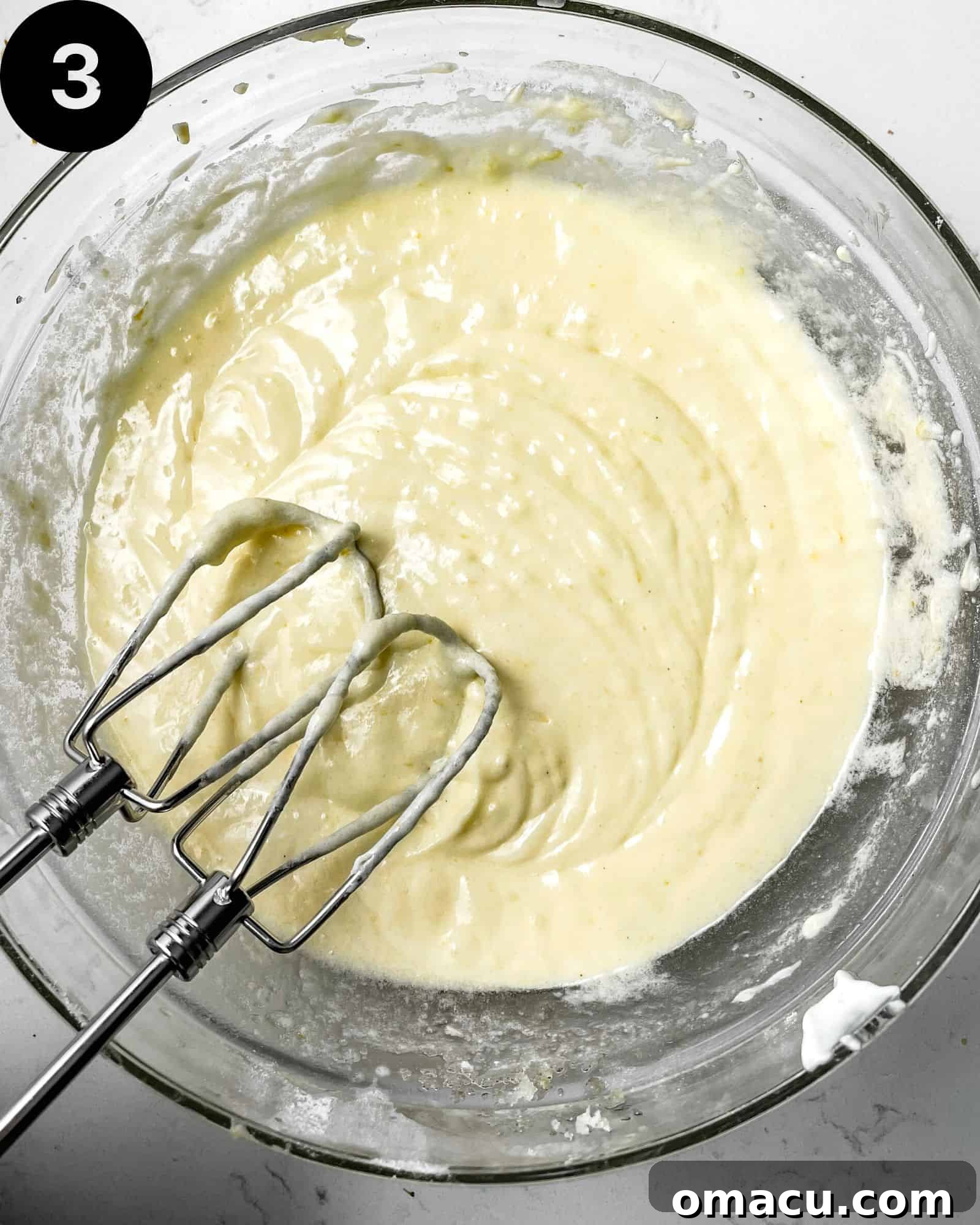 butter, sugar, oil, and eggs creamed together in a mixing bowl.