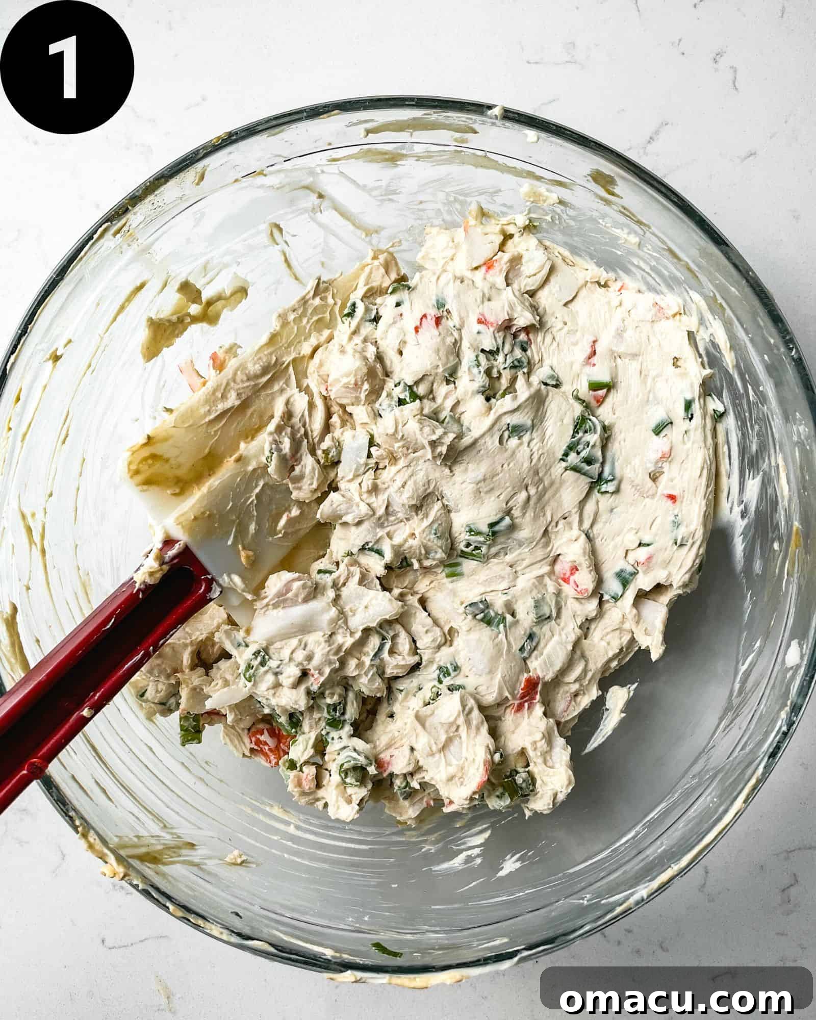 A large bowl shows the creamy mixture of cream cheese, crab meat, green onions, and various spices, perfectly blended for the crab rangoon egg roll filling.