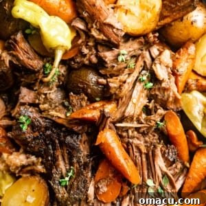 up close photo of mississippi pot roast cut into pieces with carrots and potatoes.