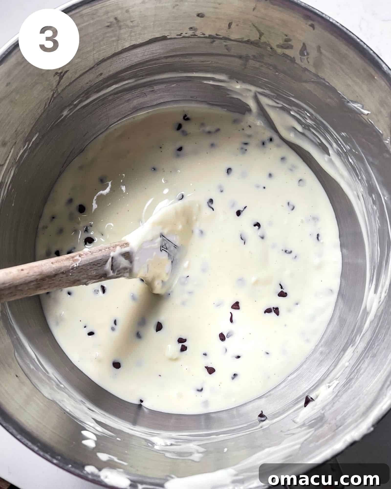 Decadent cheesecake filling generously studded with mini chocolate chips, ready to be poured into the crust.