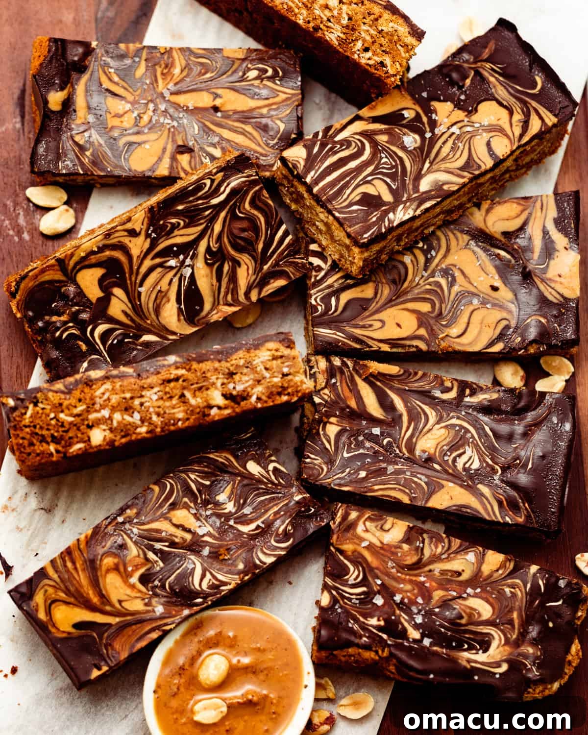 Delicious chocolate peanut butter oatmeal bars neatly cut into squares and arranged on a brown plate, ready to be enjoyed.