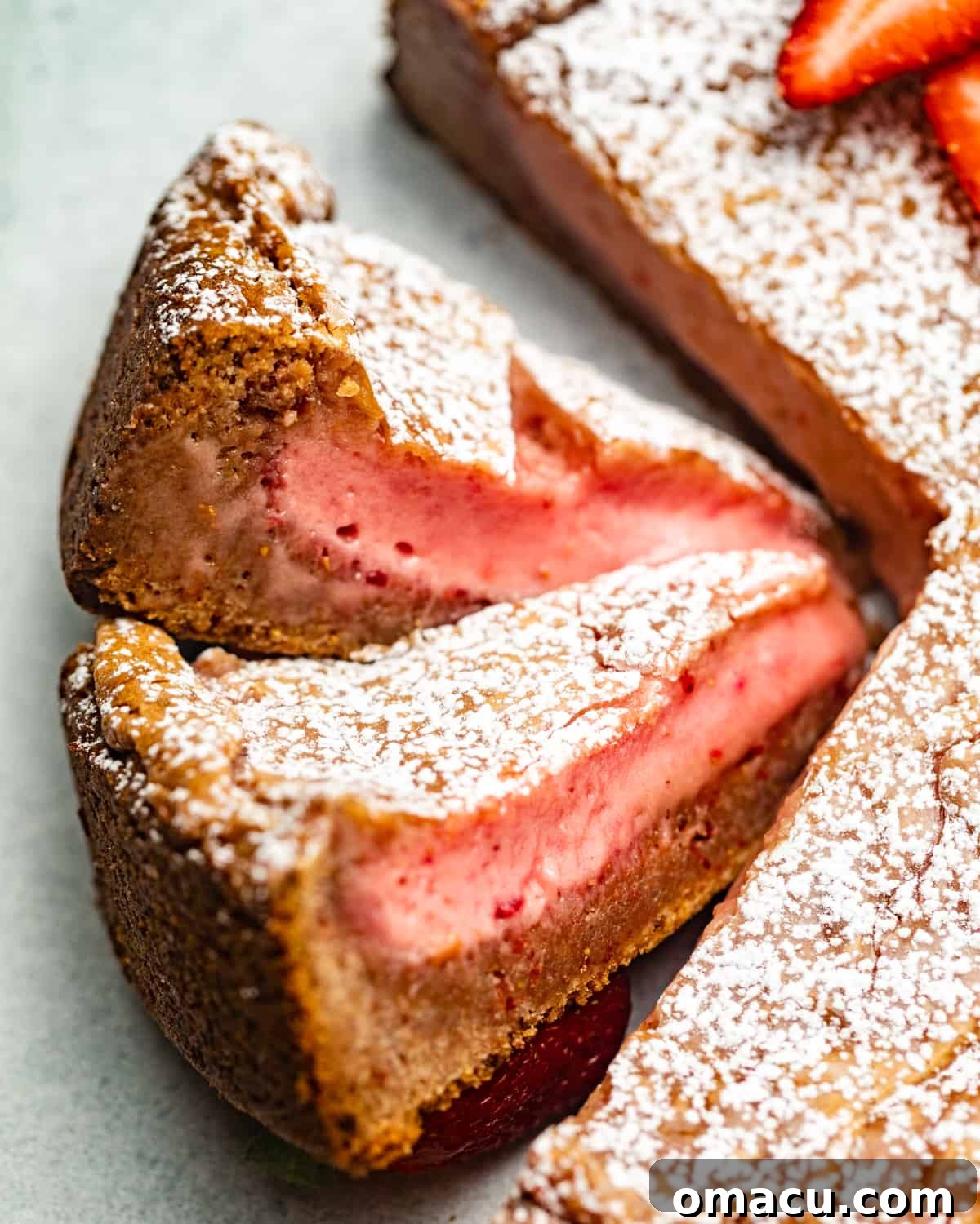 Perfectly cut strawberry cake slices, arranged to highlight their layered structure and inviting texture.