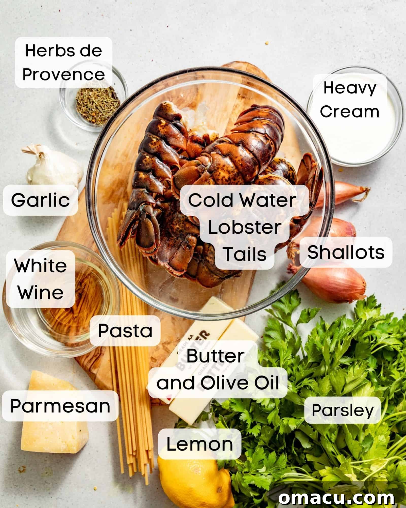 ingredients to make butter poached lobster - lobster tails, butter, olive oil, shallots, garlic, red pepper flakes, herbs de provence, white wine, heavy cream, parmesan, parsley, lemon juice.