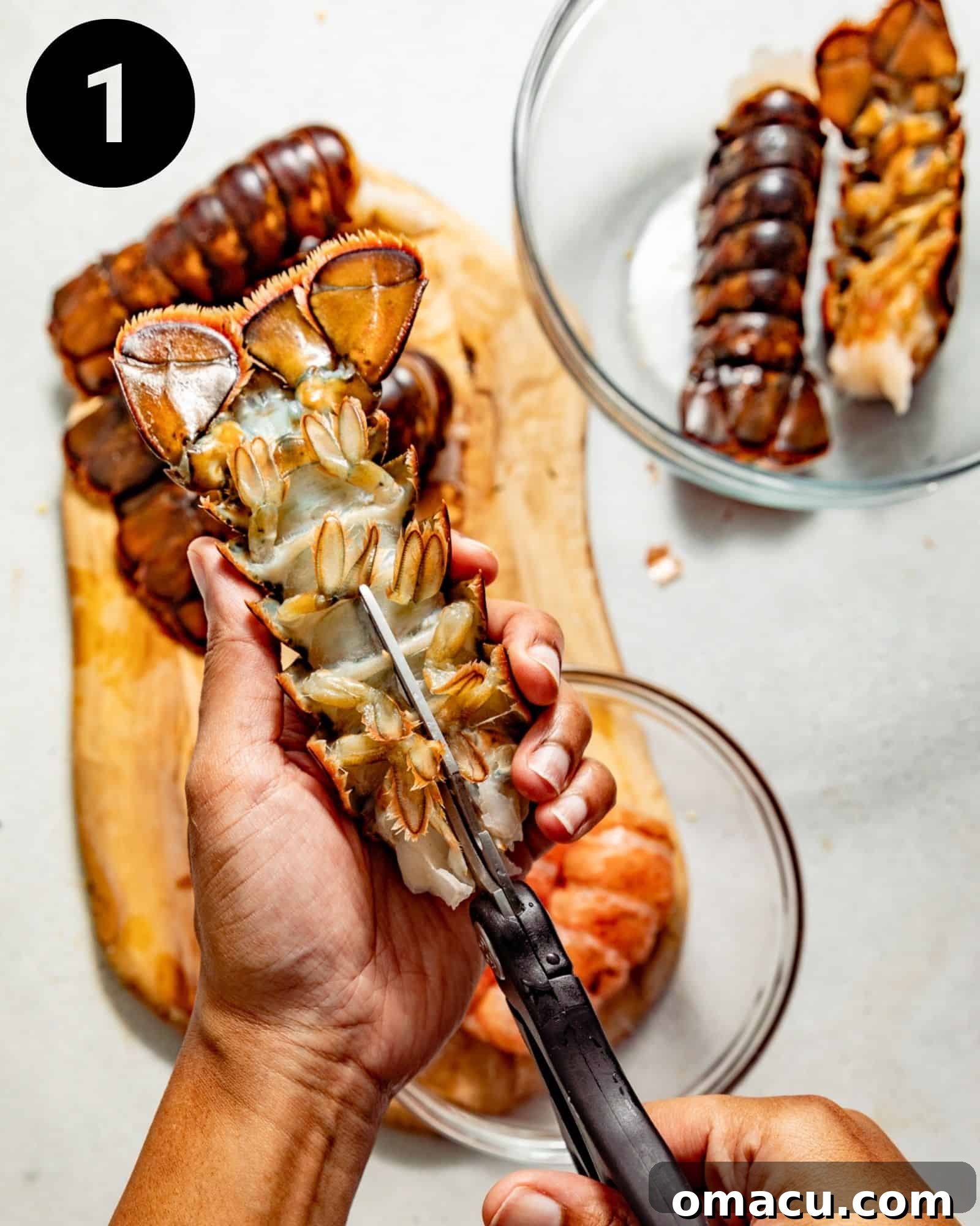 kitchen shears cutting open a lobster tail.