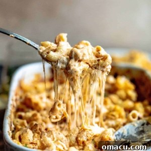 A bubbling casserole of creamy baked macaroni and cheese, topped with golden-brown deliciousness, ready to be served.