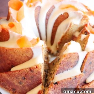 A slice of beautifully glazed carrot cake on a plate, showcasing its moist texture and rich flavors.